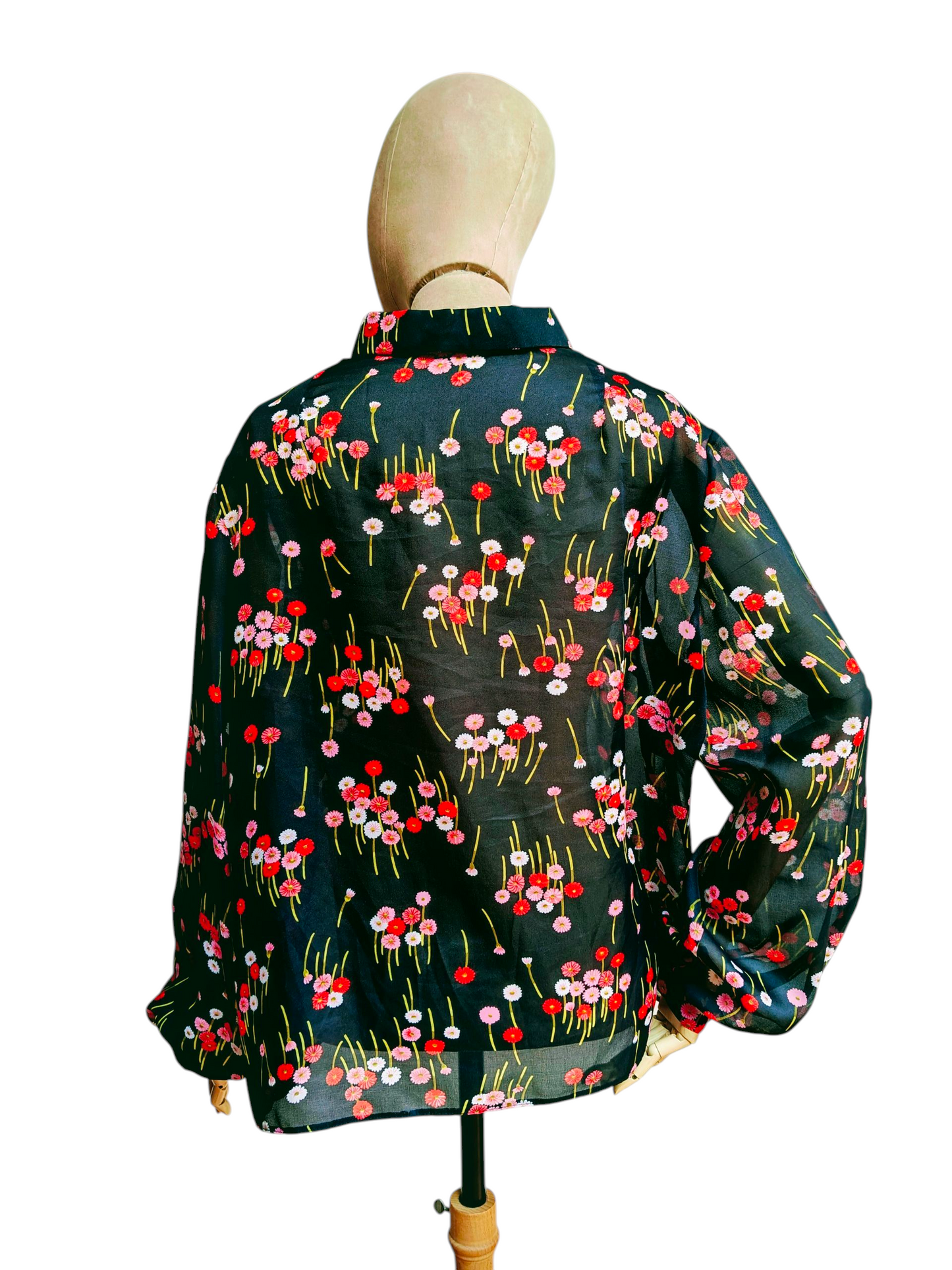 Floral-patterned shirt on a mannequin against a white background