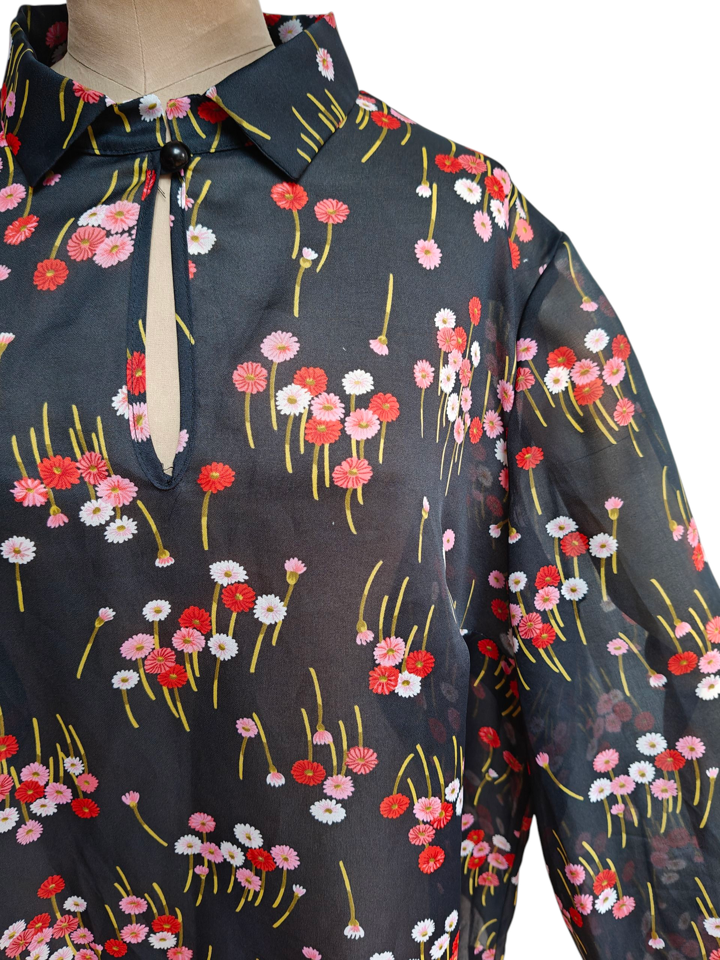 Floral patterned shirt with red, pink, and white flowers on a dark background