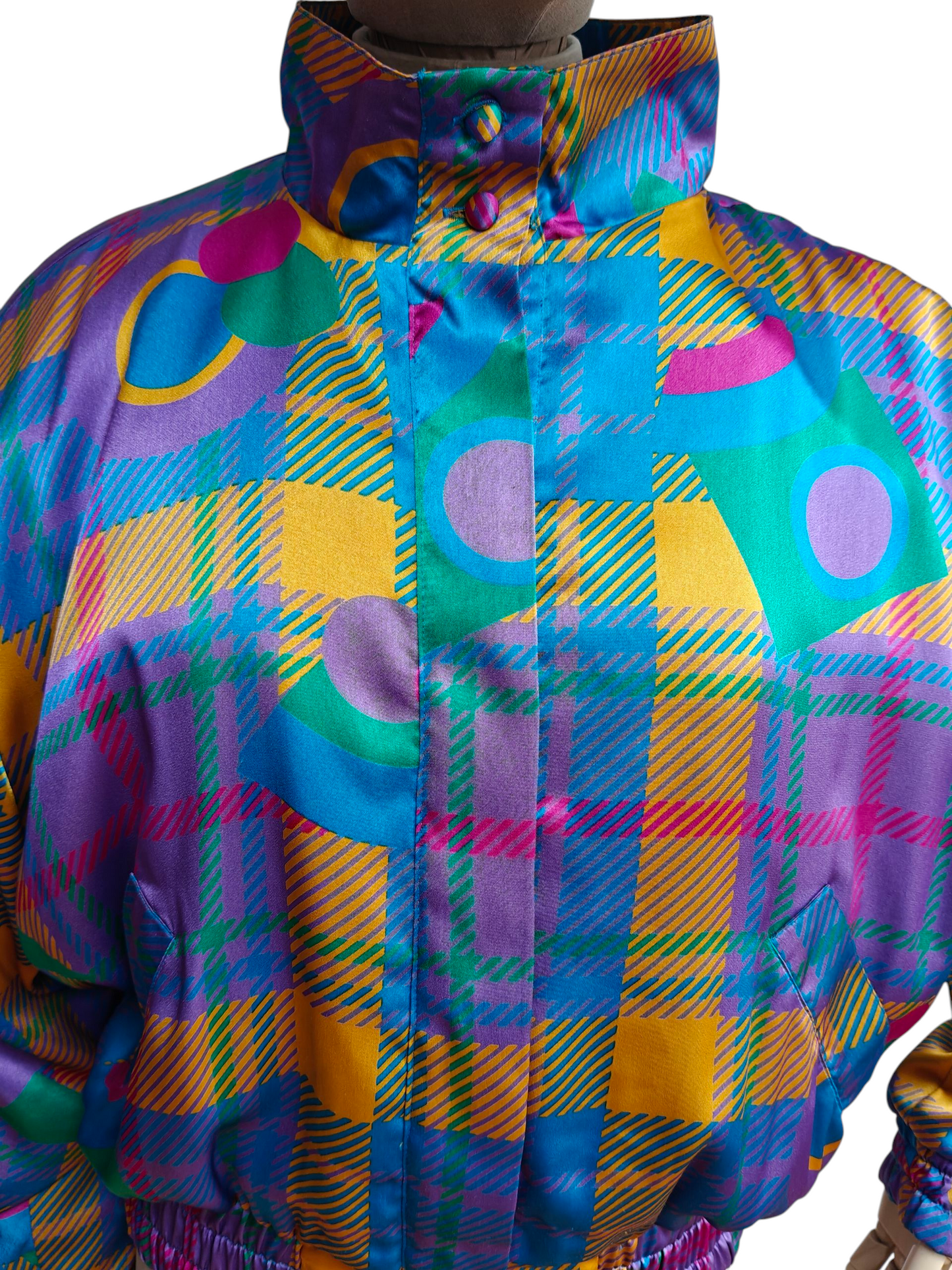 Colorful plaid jacket with geometric patterns on a white background