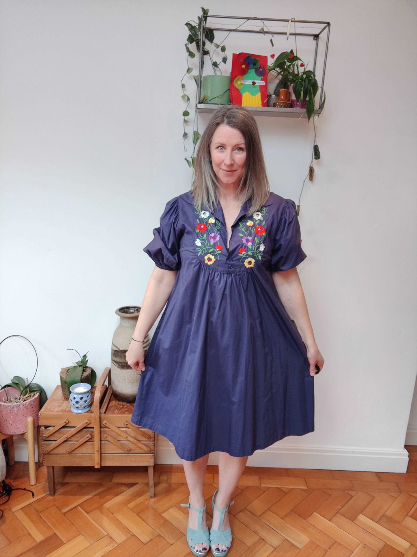 Beautiful blue smock dress with embroidered bib detail.