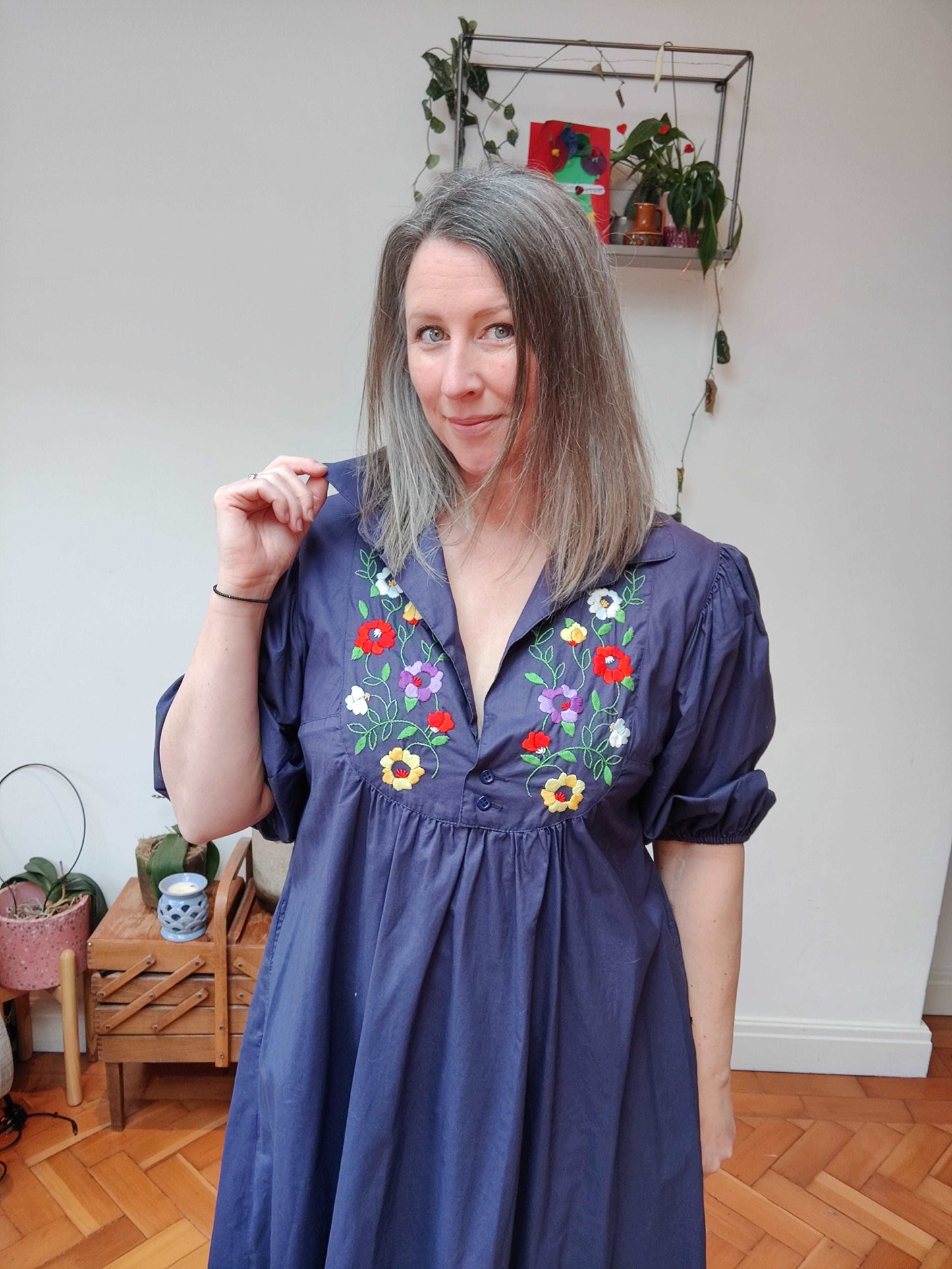 Beautiful blue smock dress with embroidered bib detail.