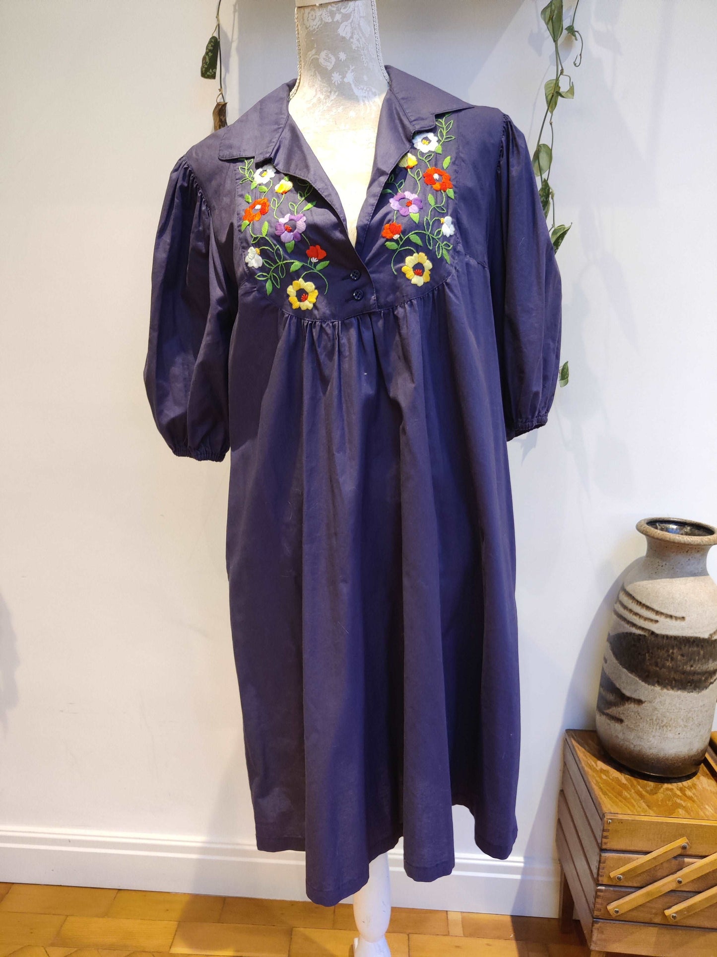Beautiful blue smock dress with embroidered bib detail.
