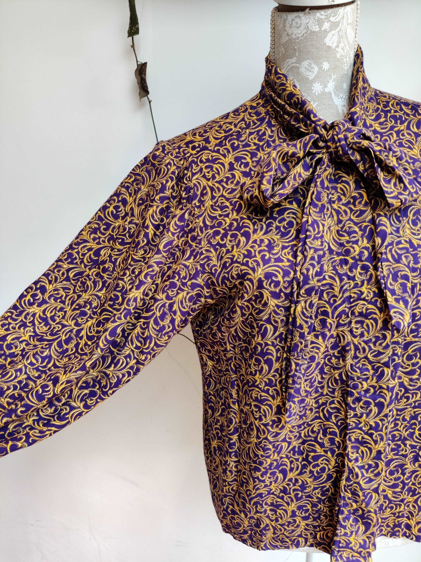 Beautiful 80s pussybow blouse in purple and gold print. Size 12-14.