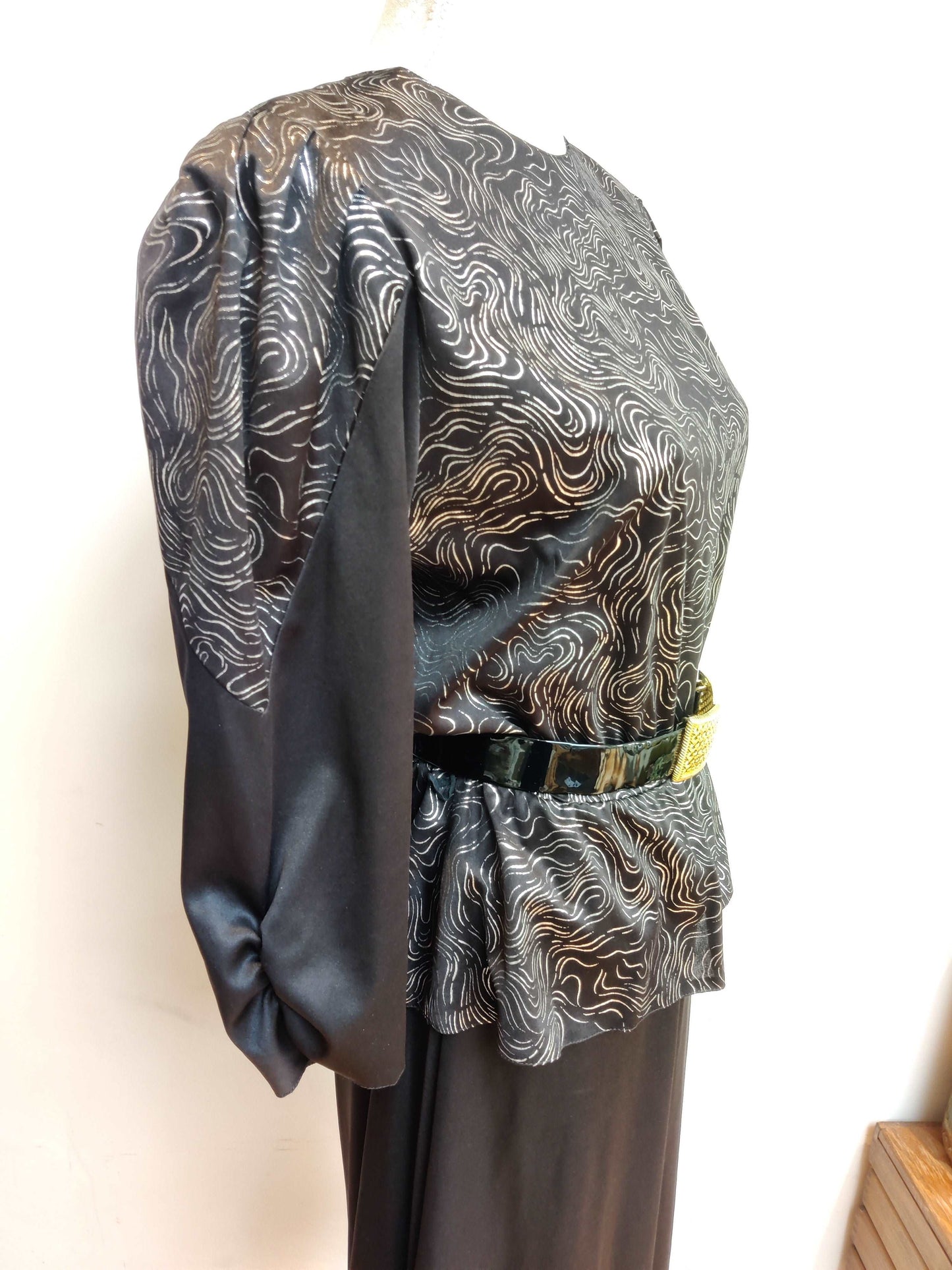 80s black and silver midi dress with peplum detail.