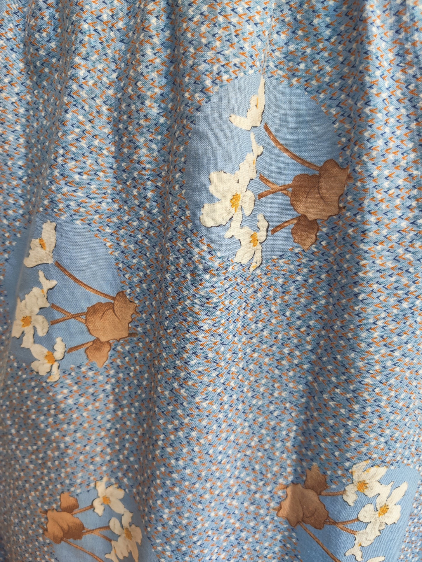 Pretty blue print with brown and cream floral detail.