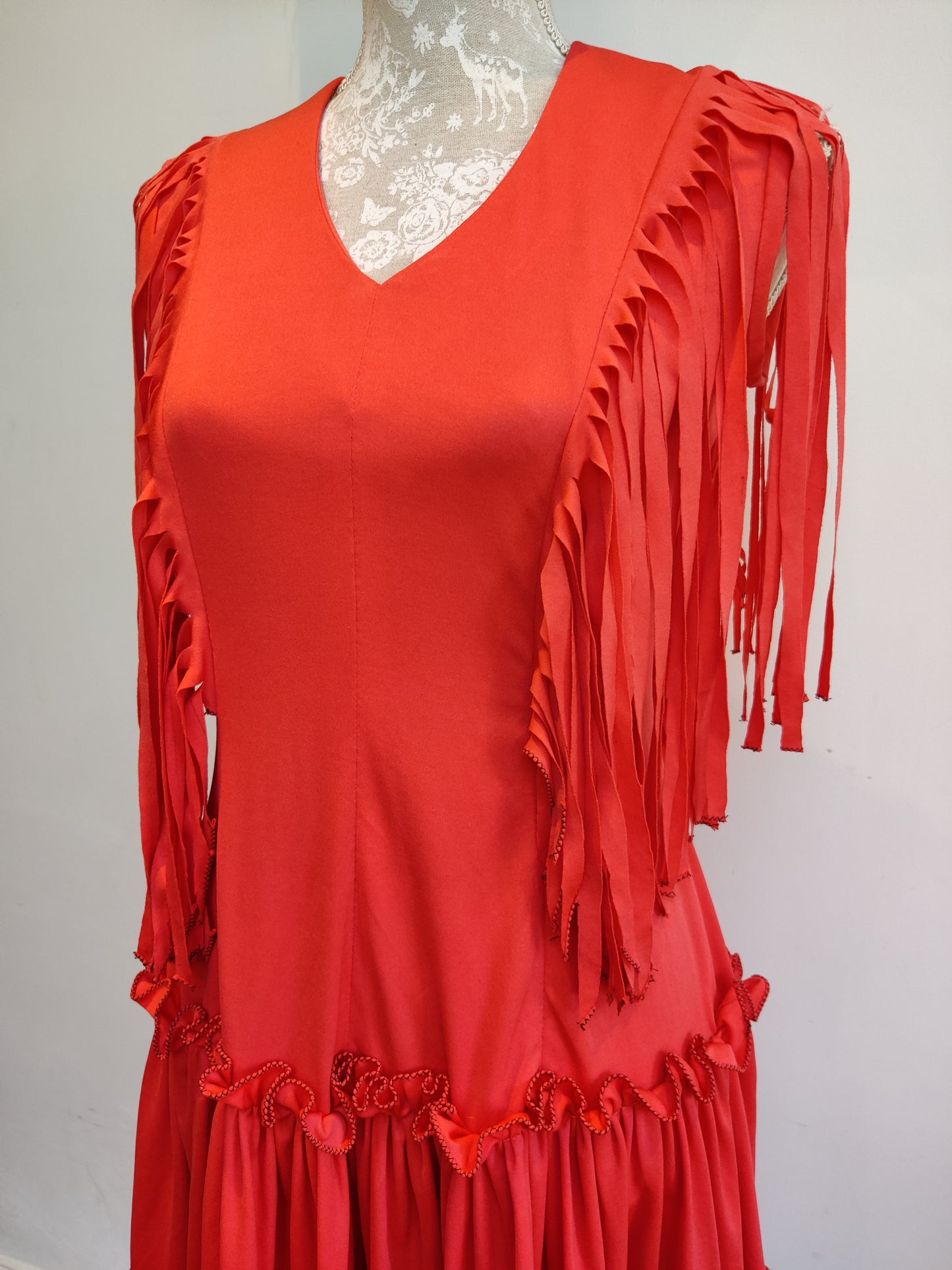 Red and black vintage dress with tassel trim.