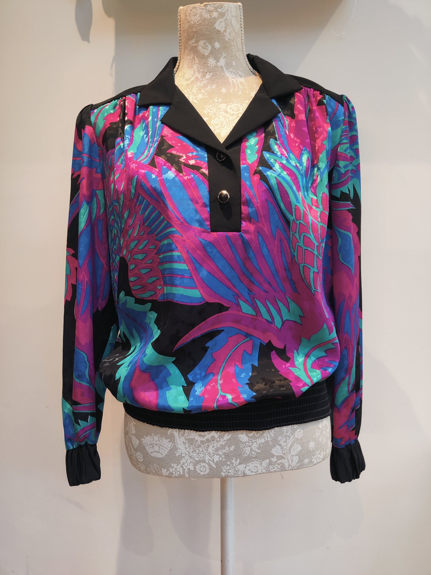 Vintage top with black pink and blue design.