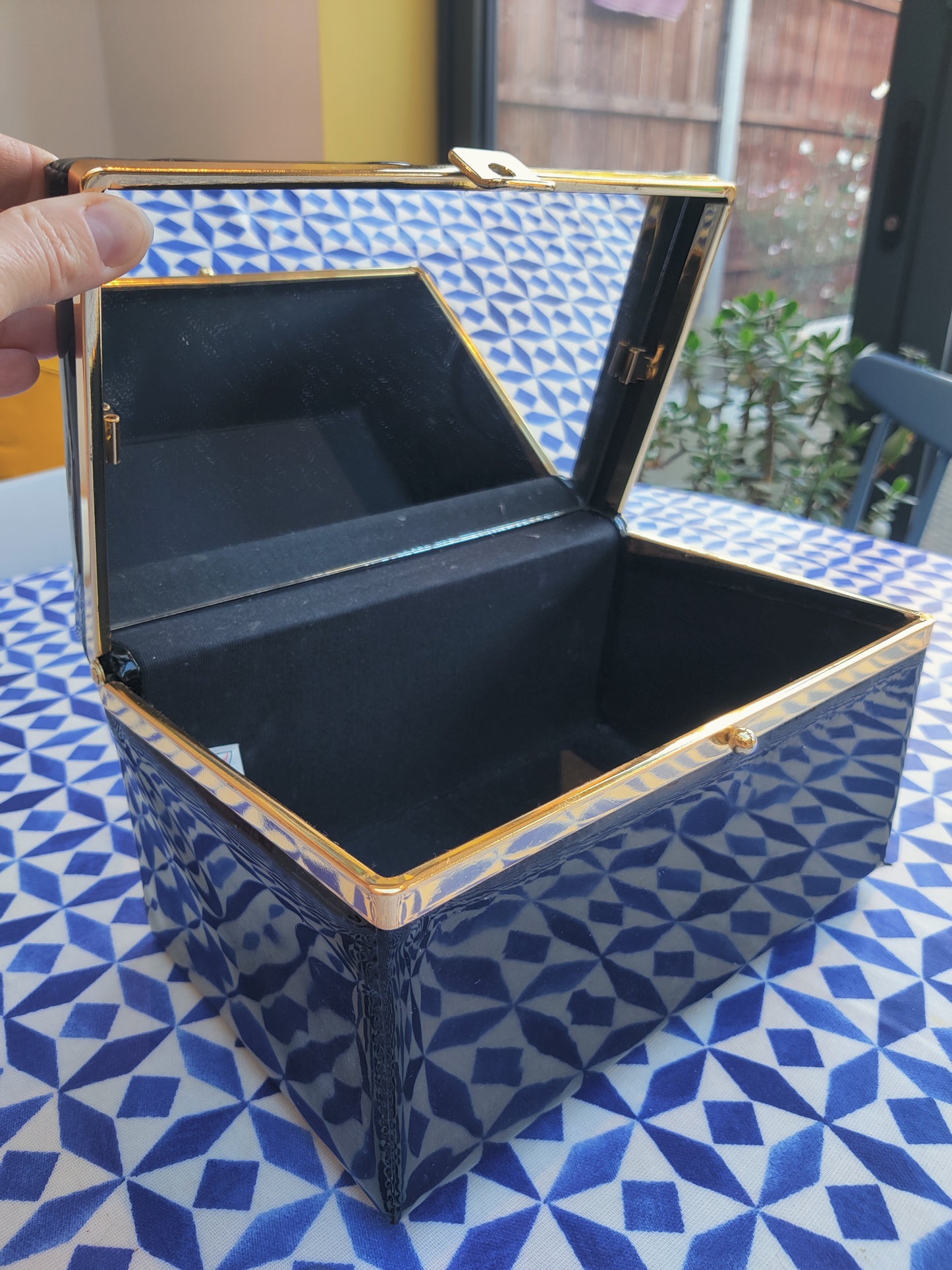 Vintage vanity bag in black and gold with mirror.