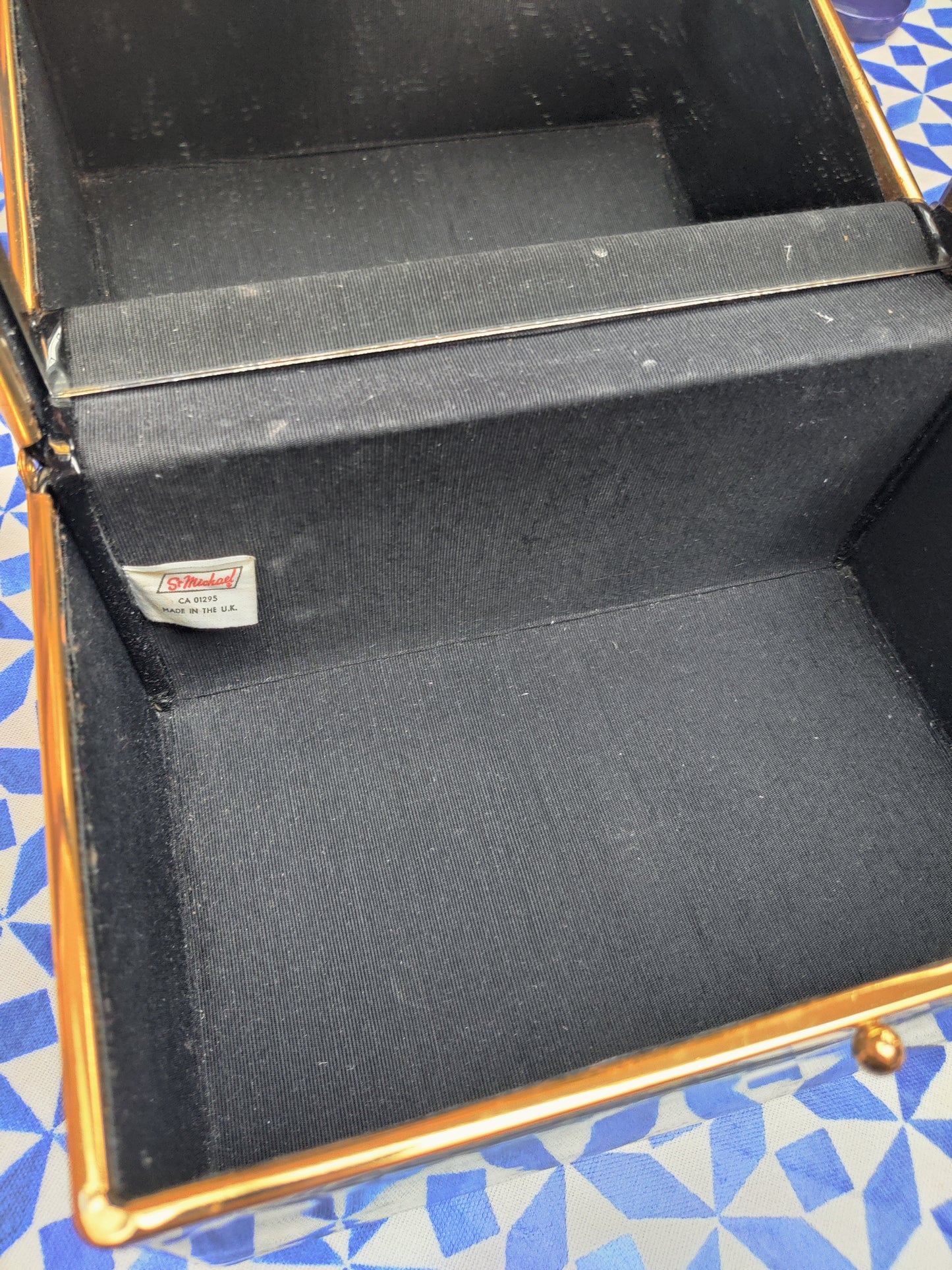 Black patent vanity case with mirror inside.