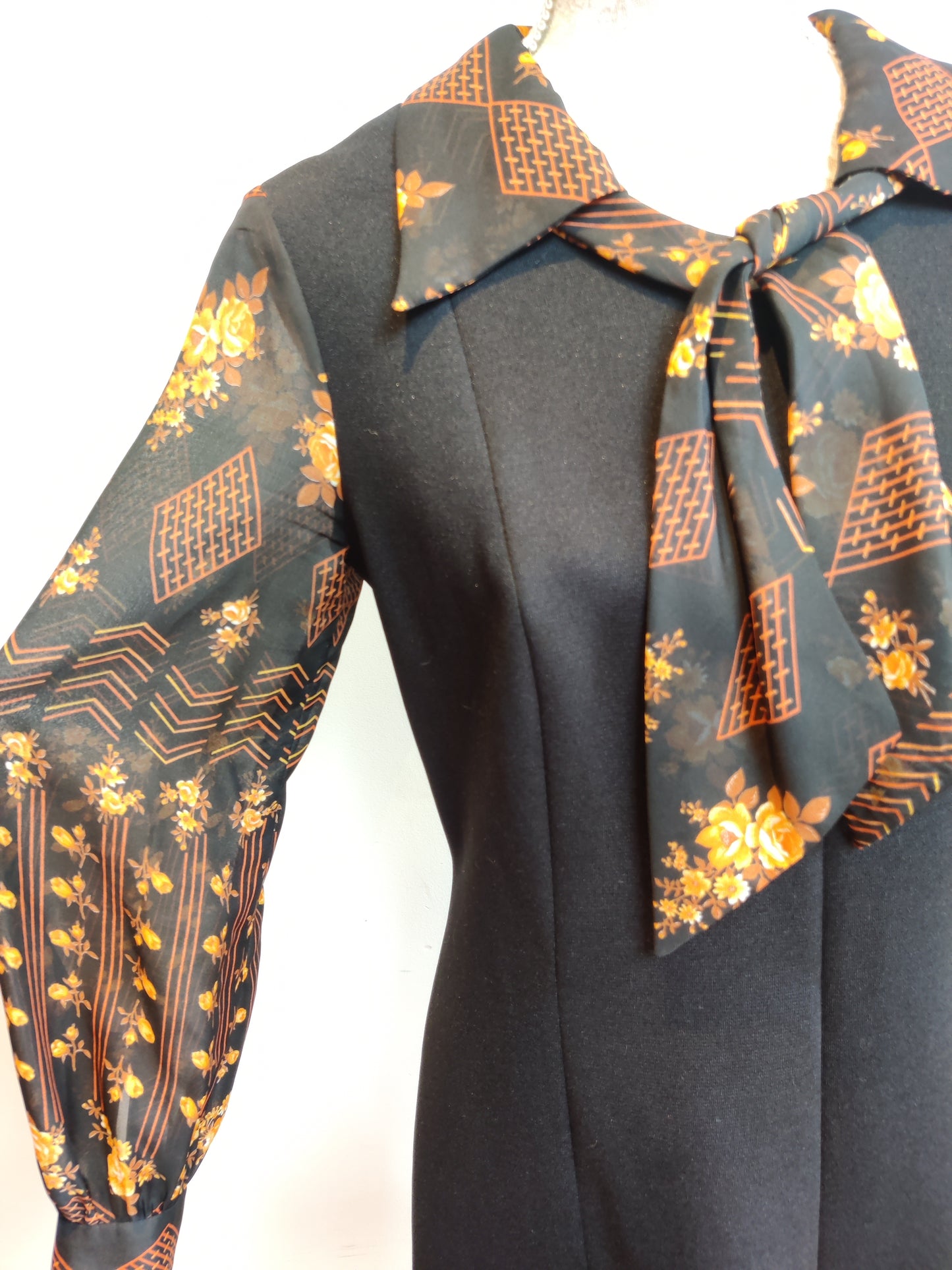 Very flattering vintage dress with semi sheer long sleeves.