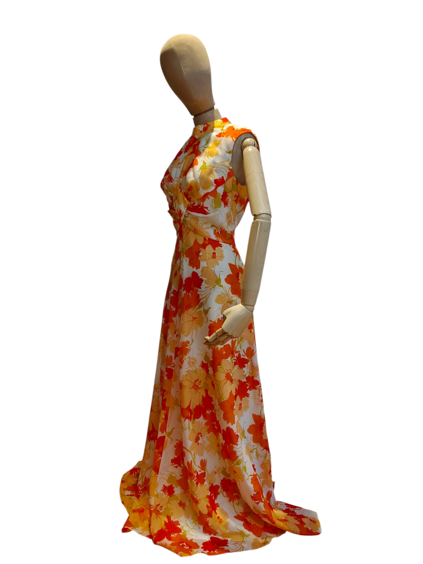 Mannequin wearing a 1970s floral dress with orange, yellow, and white colours on a white background