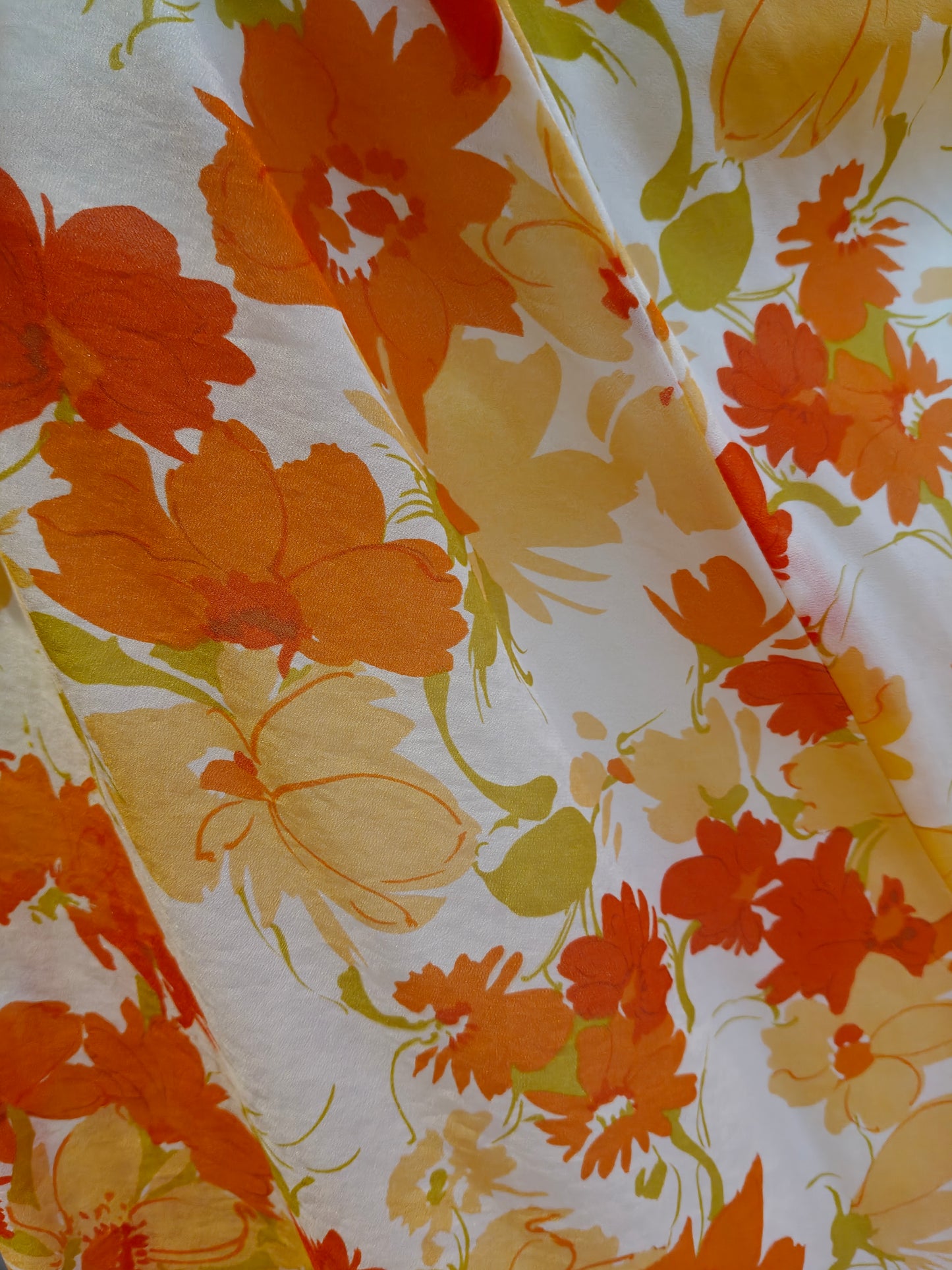Floral fabric with orange and yellow flowers on a white background
