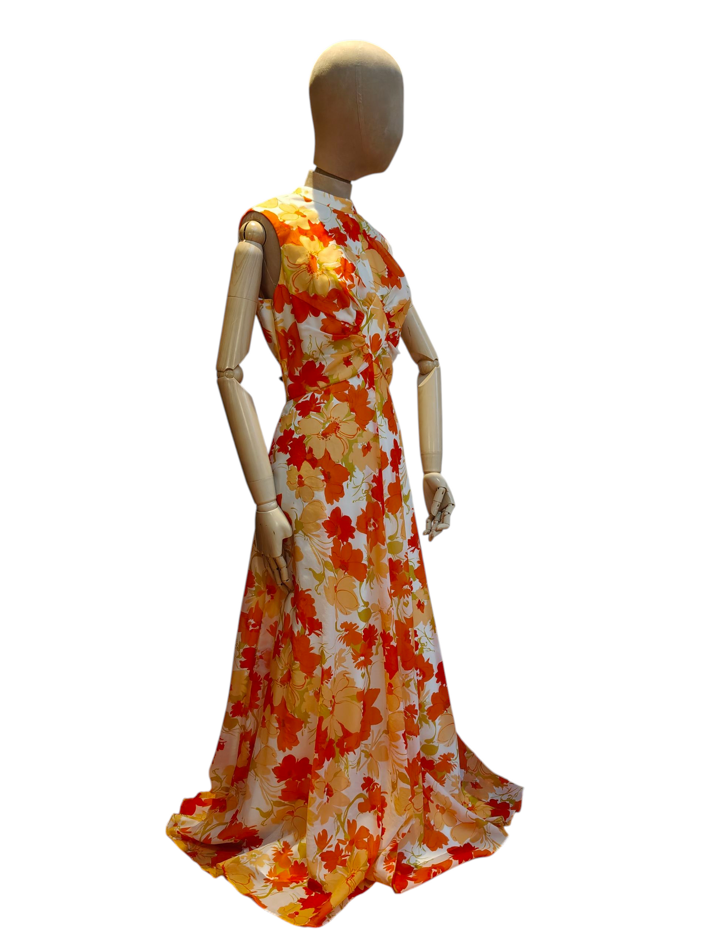 Mannequin wearing a floral dress with orange, yellow, and white pattern on a white background