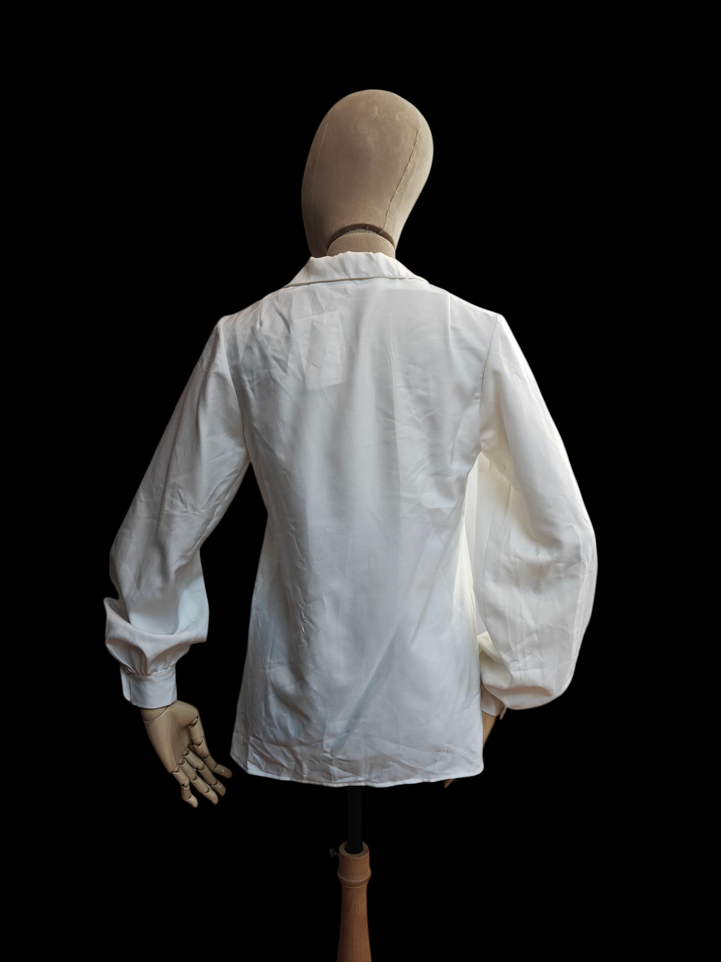 White vintage shirt on a mannequin against a black background
