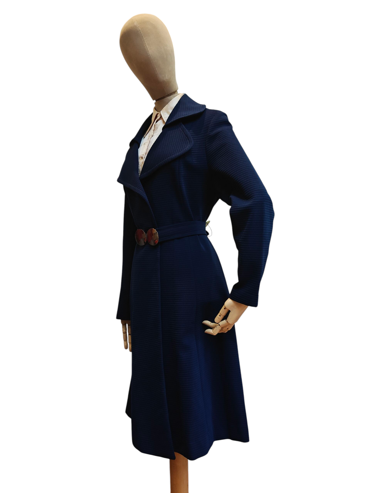 Navy blue coat on a mannequin against a white background