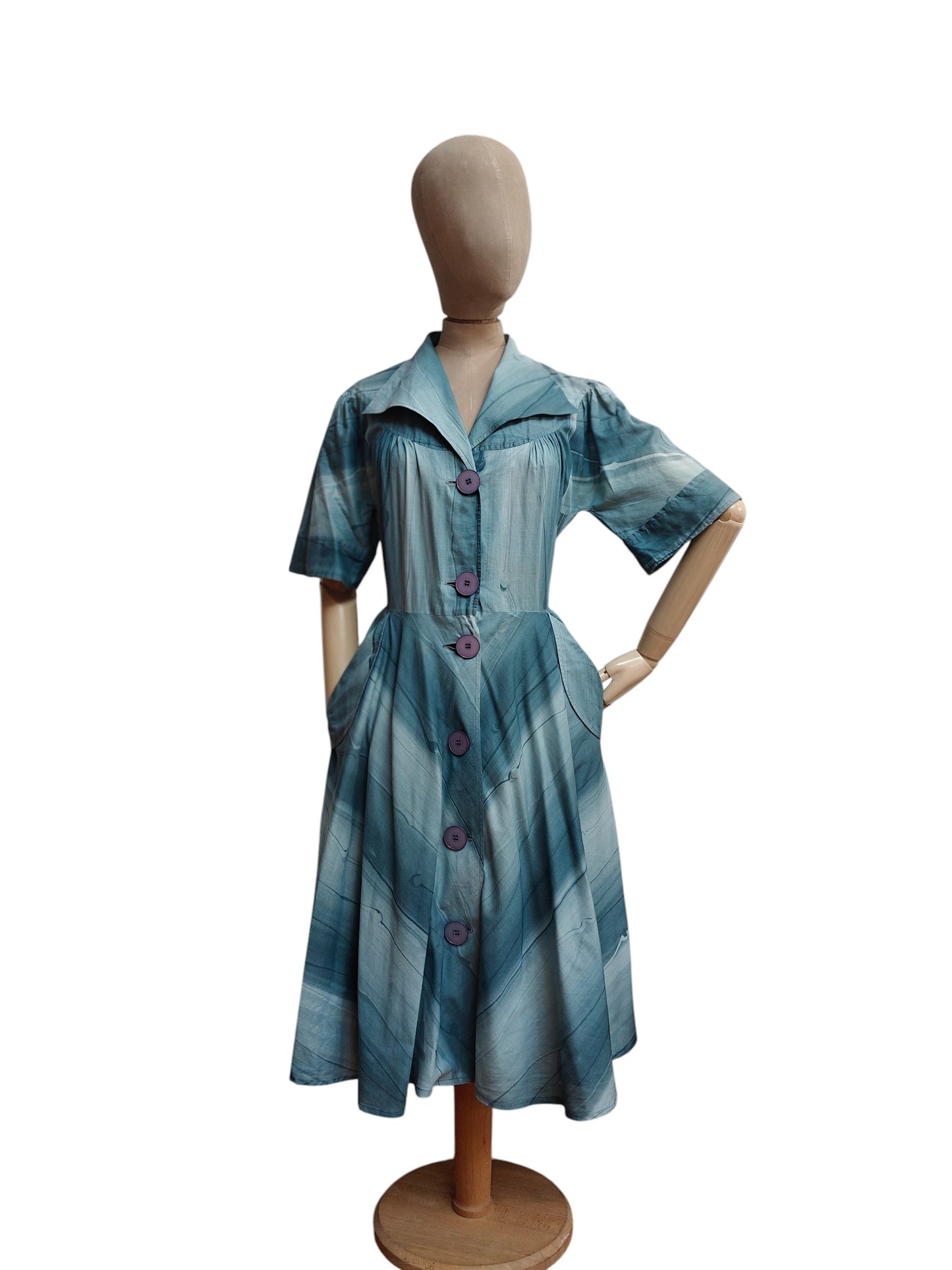 Blue striped dress on a mannequin against a white background