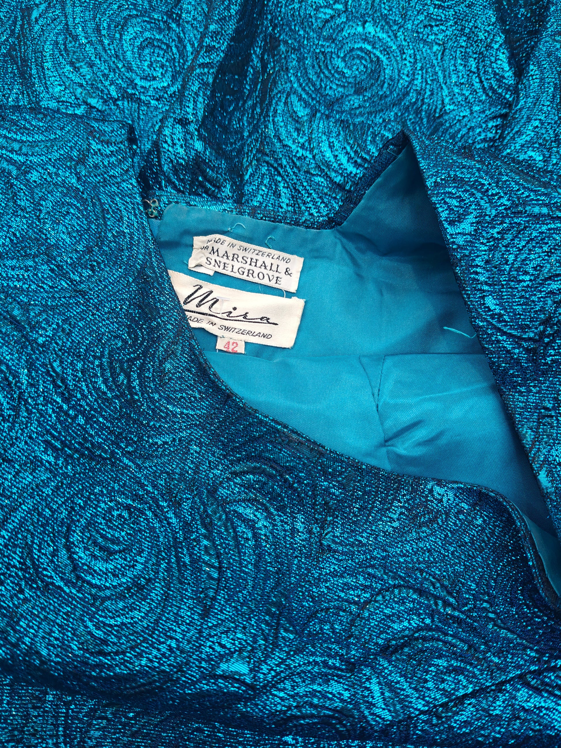 Blue textured fabric with a tag on a matching background