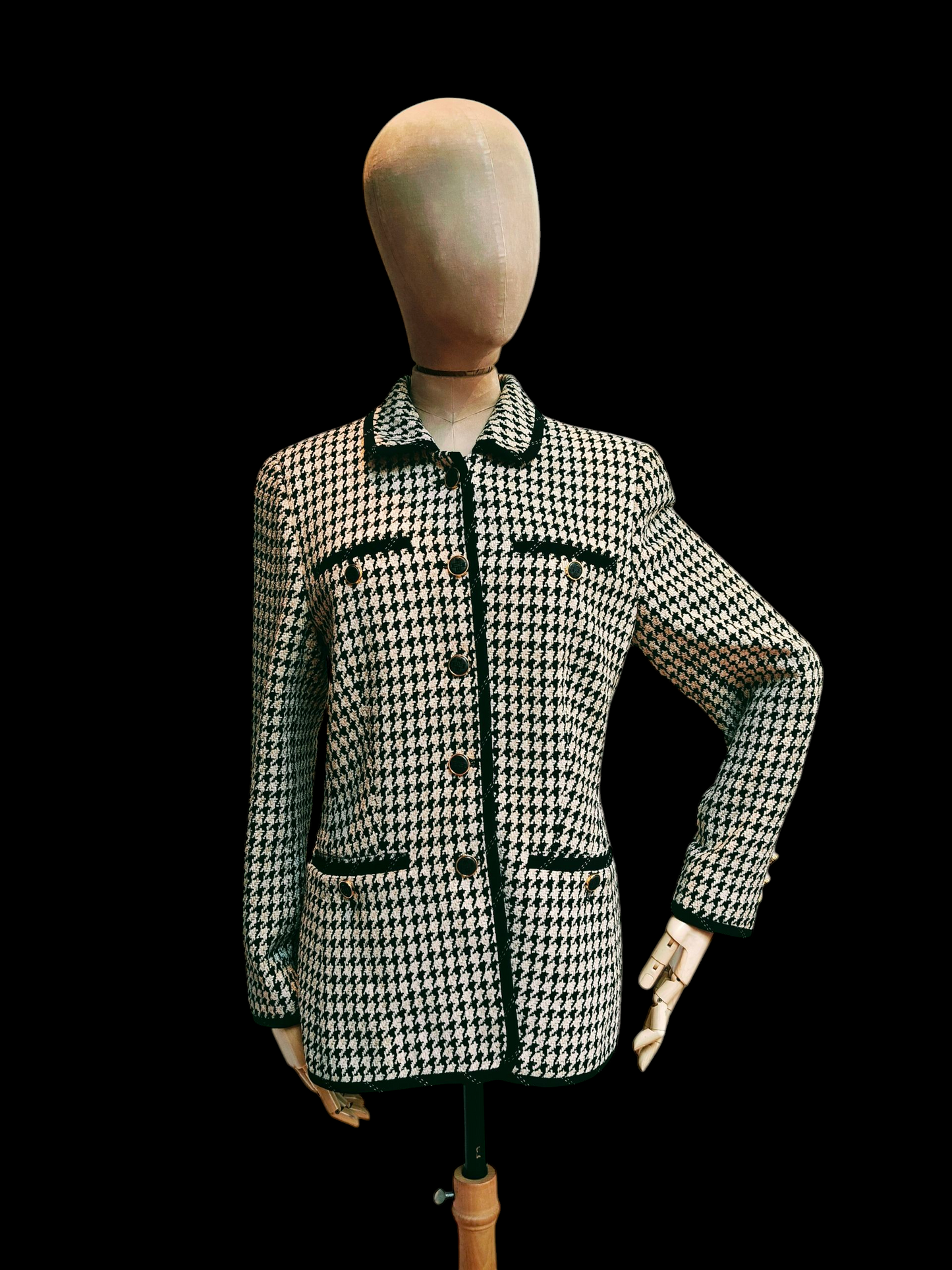 Houndstooth patterned jacket on a mannequin against a black background