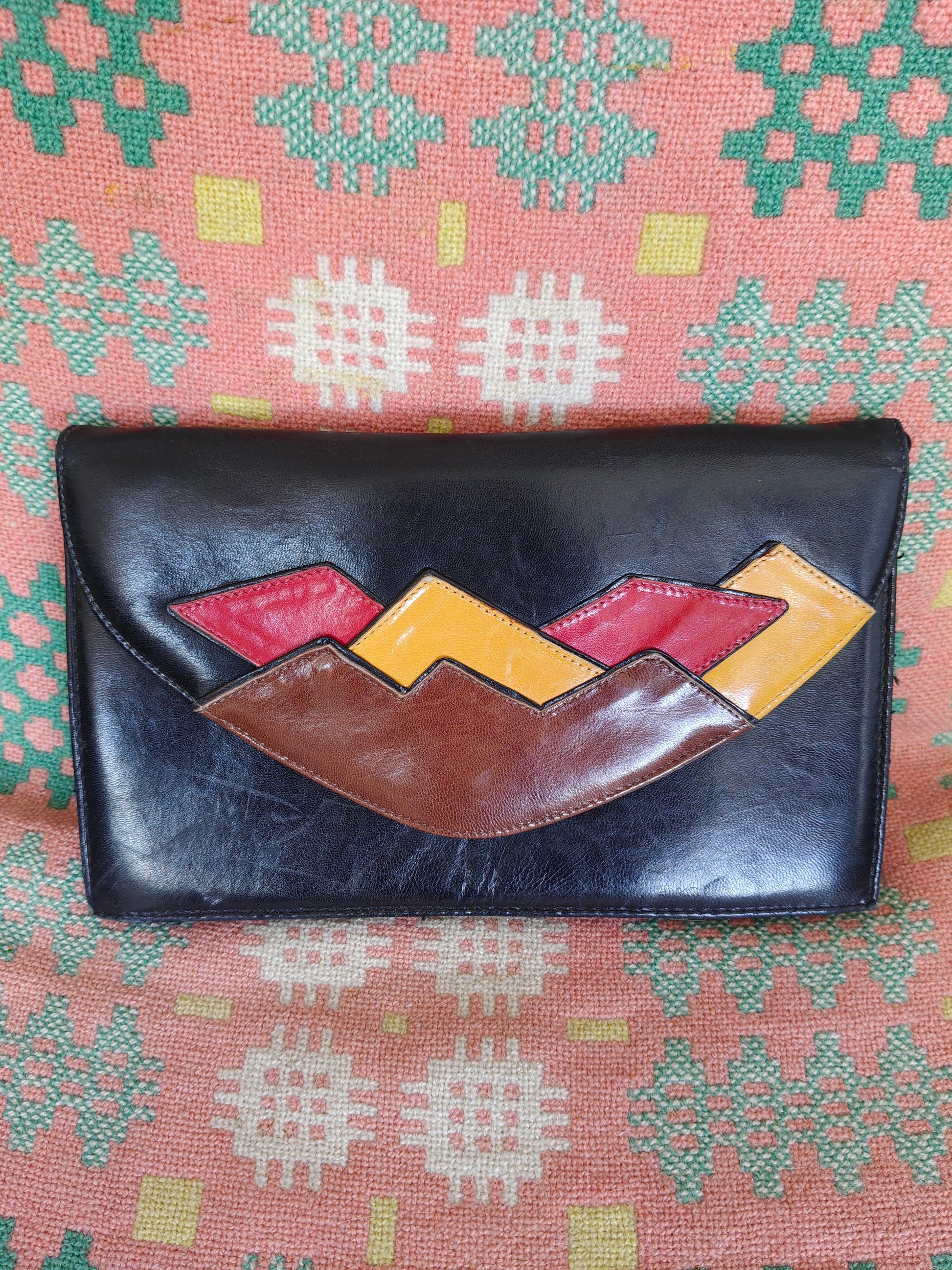 80s clutch bag in black, red, brown and yellow
