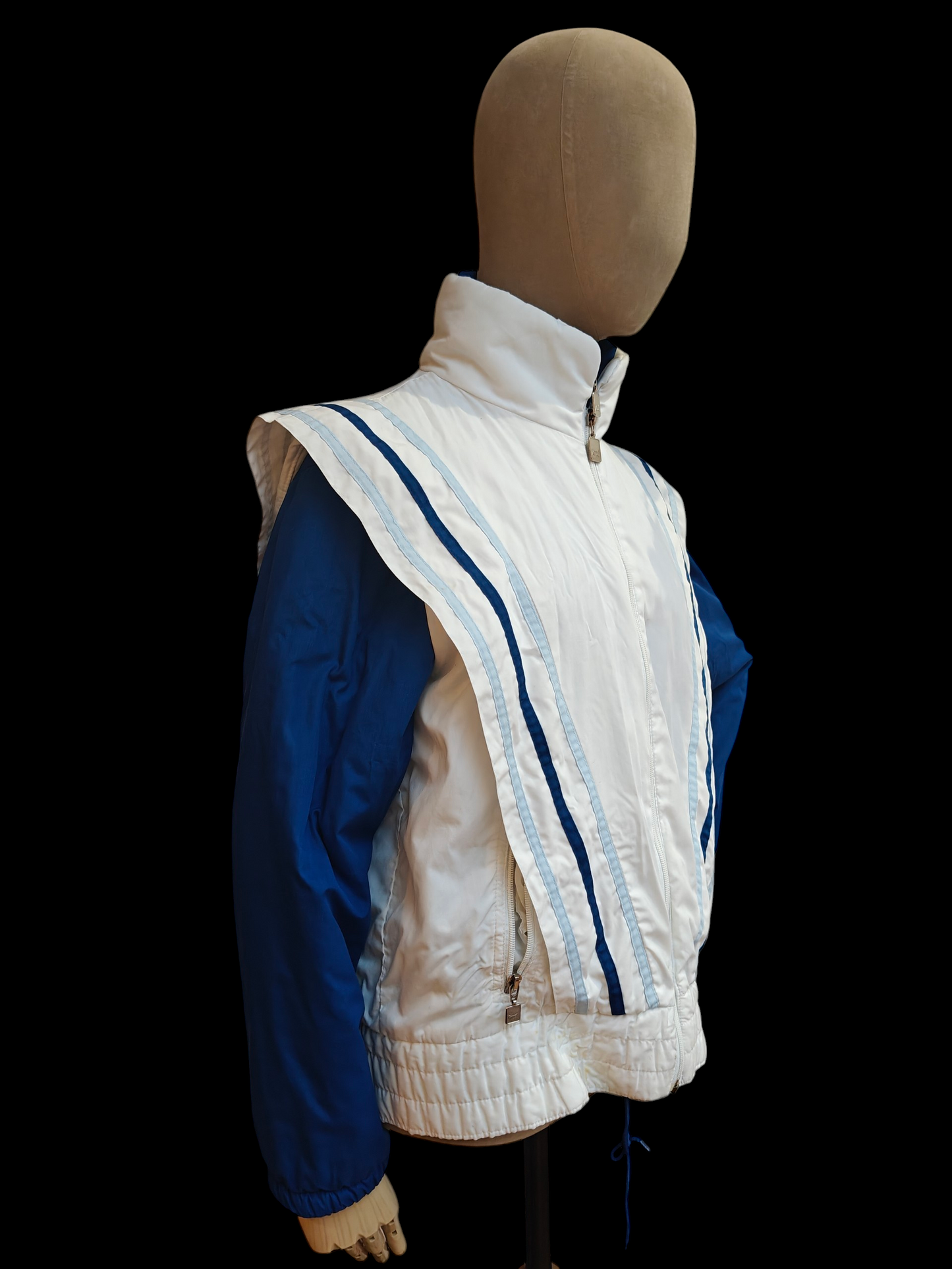 Mannequin wearing a white quilted vest with blue stripes on a black background