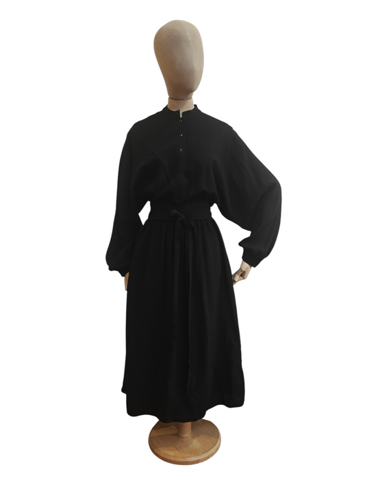 Black dress on a mannequin against a white background