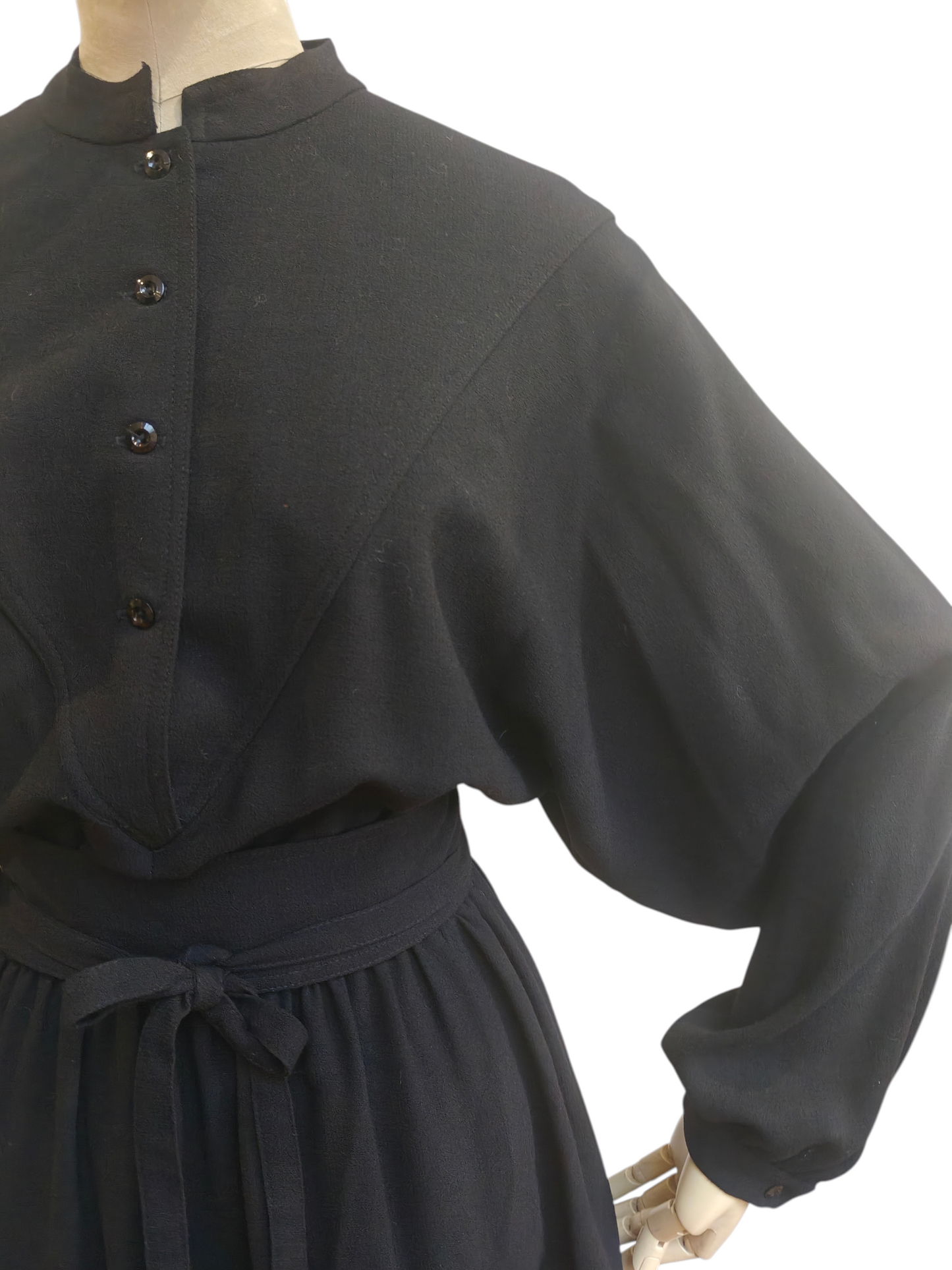 Black 80's dress with batwing sleeves on a white background