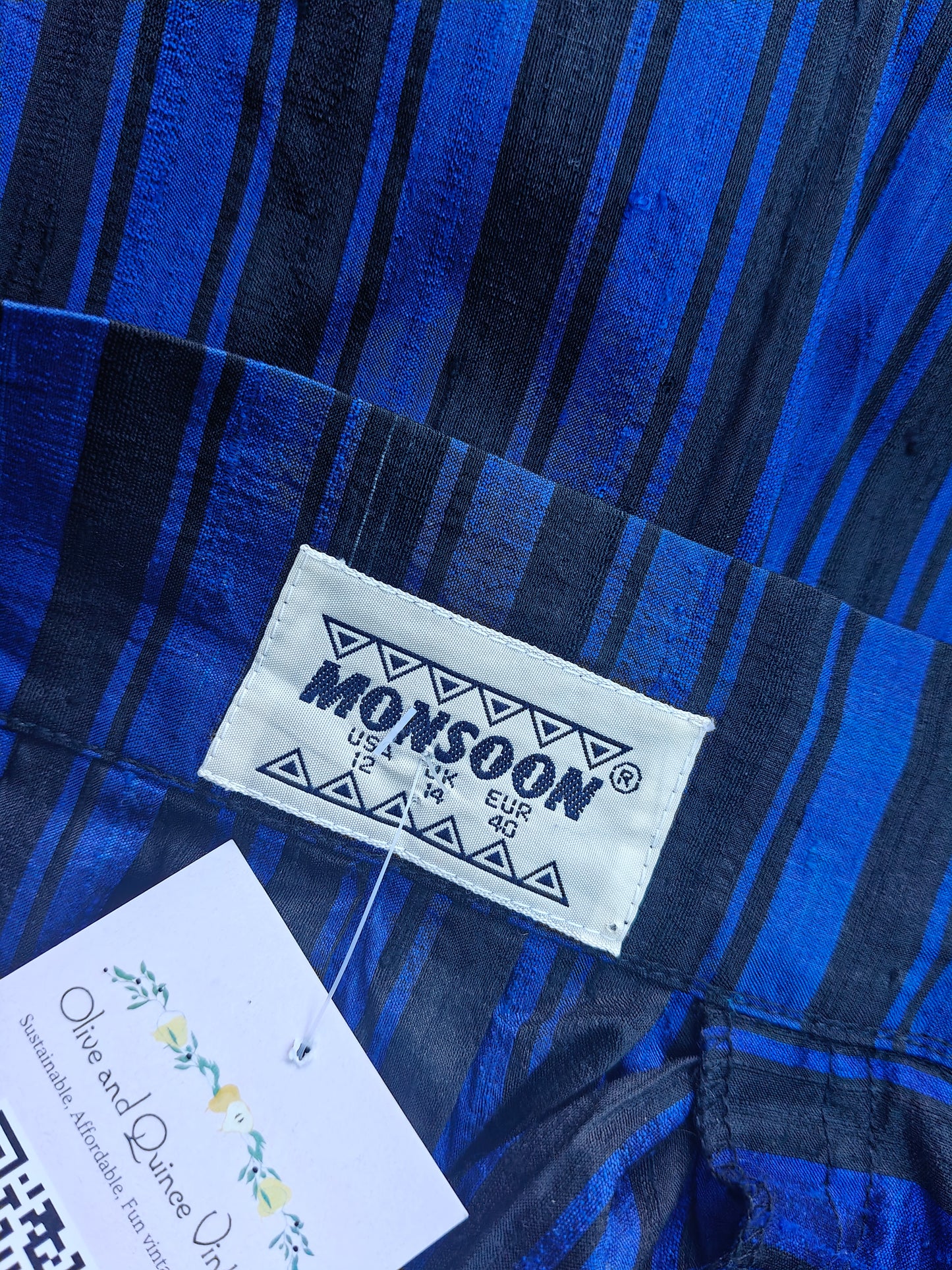 Close-up of a blue and black striped skirt with a 'Monsoon' label.