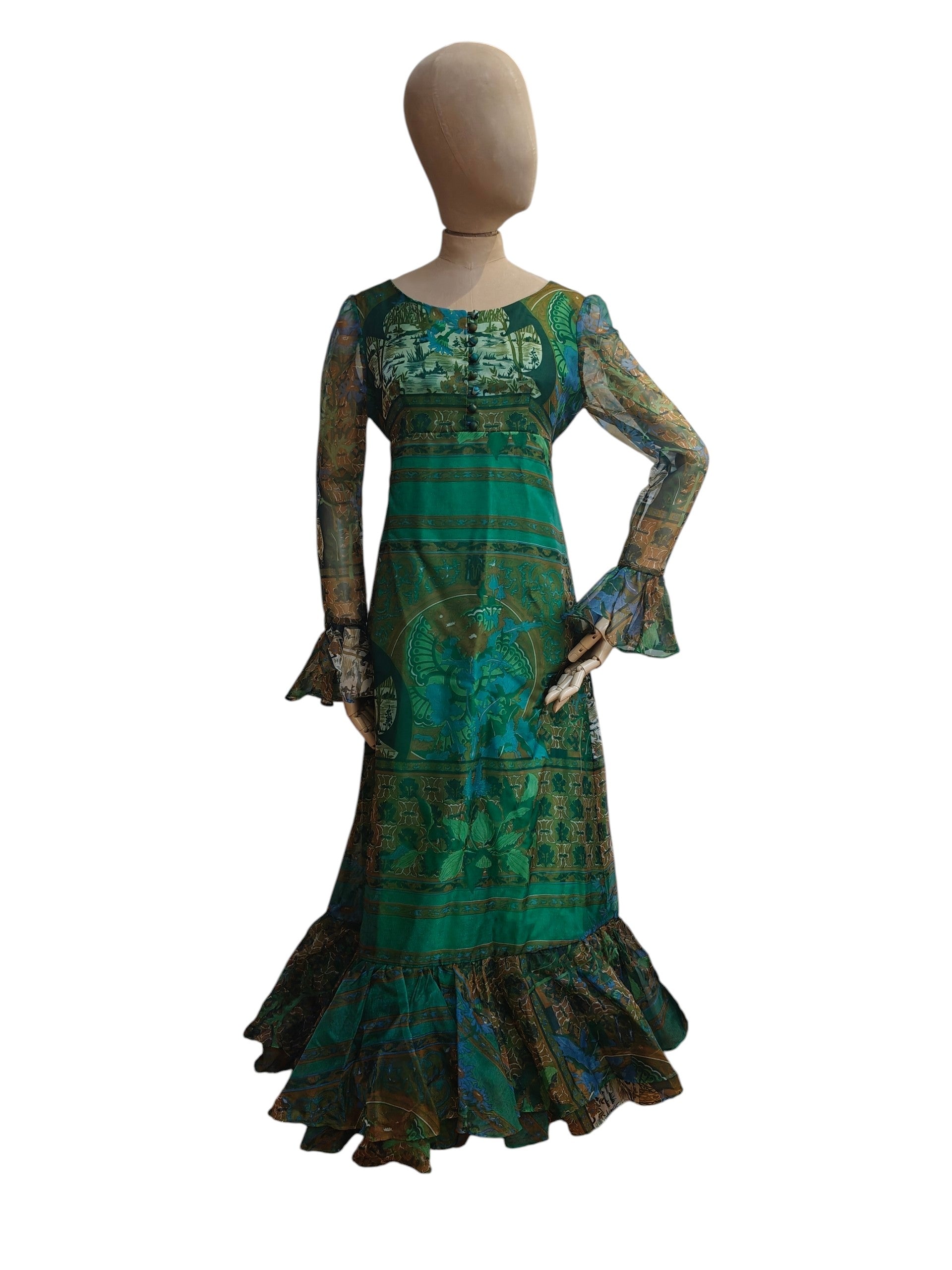 Mannequin wearing a green patterned dress on a white background