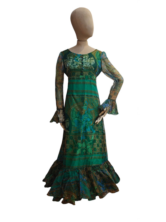 Mannequin wearing a green patterned dress on a white background