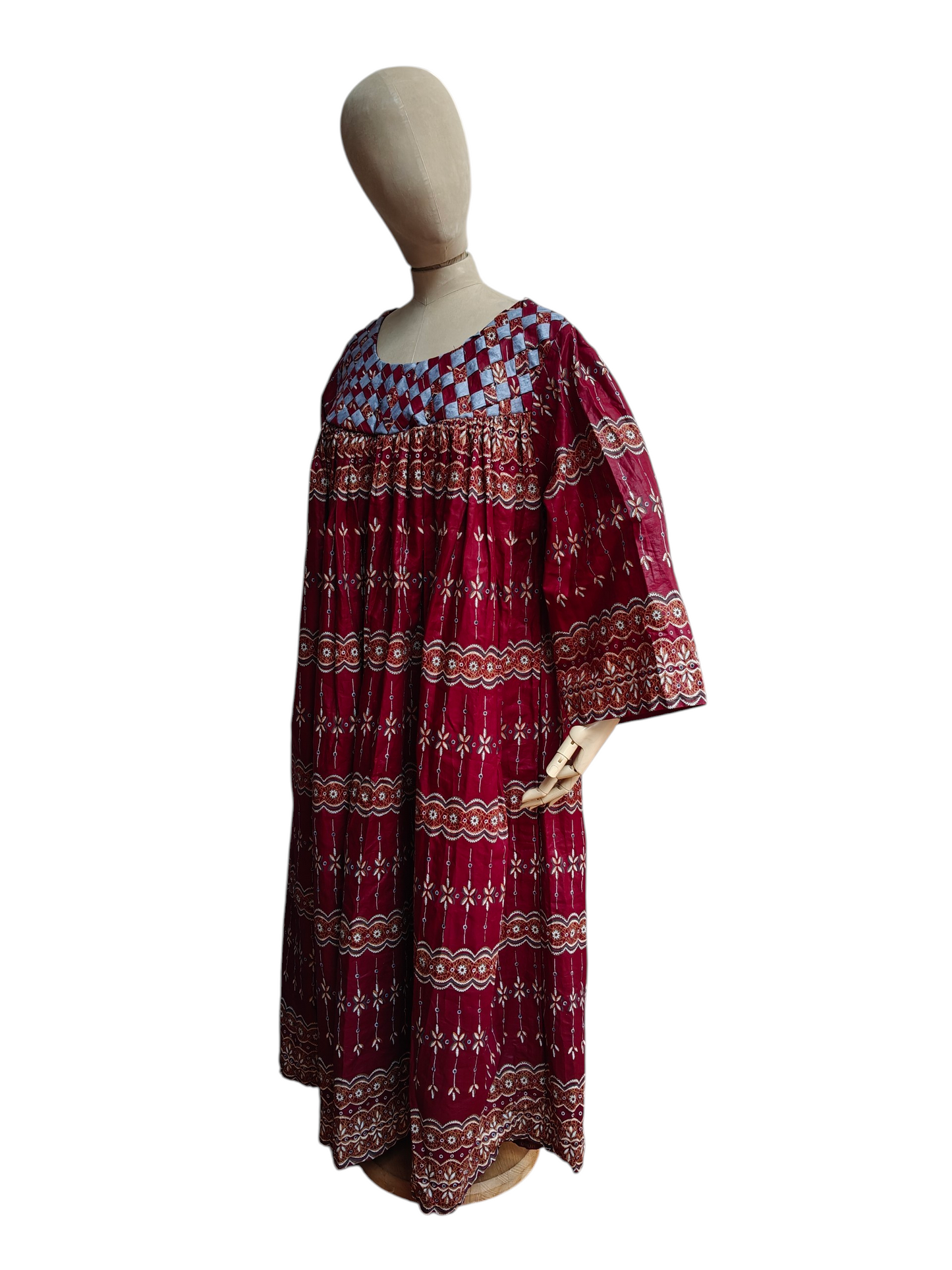 Red plus size patterned dress on a mannequin against a white background