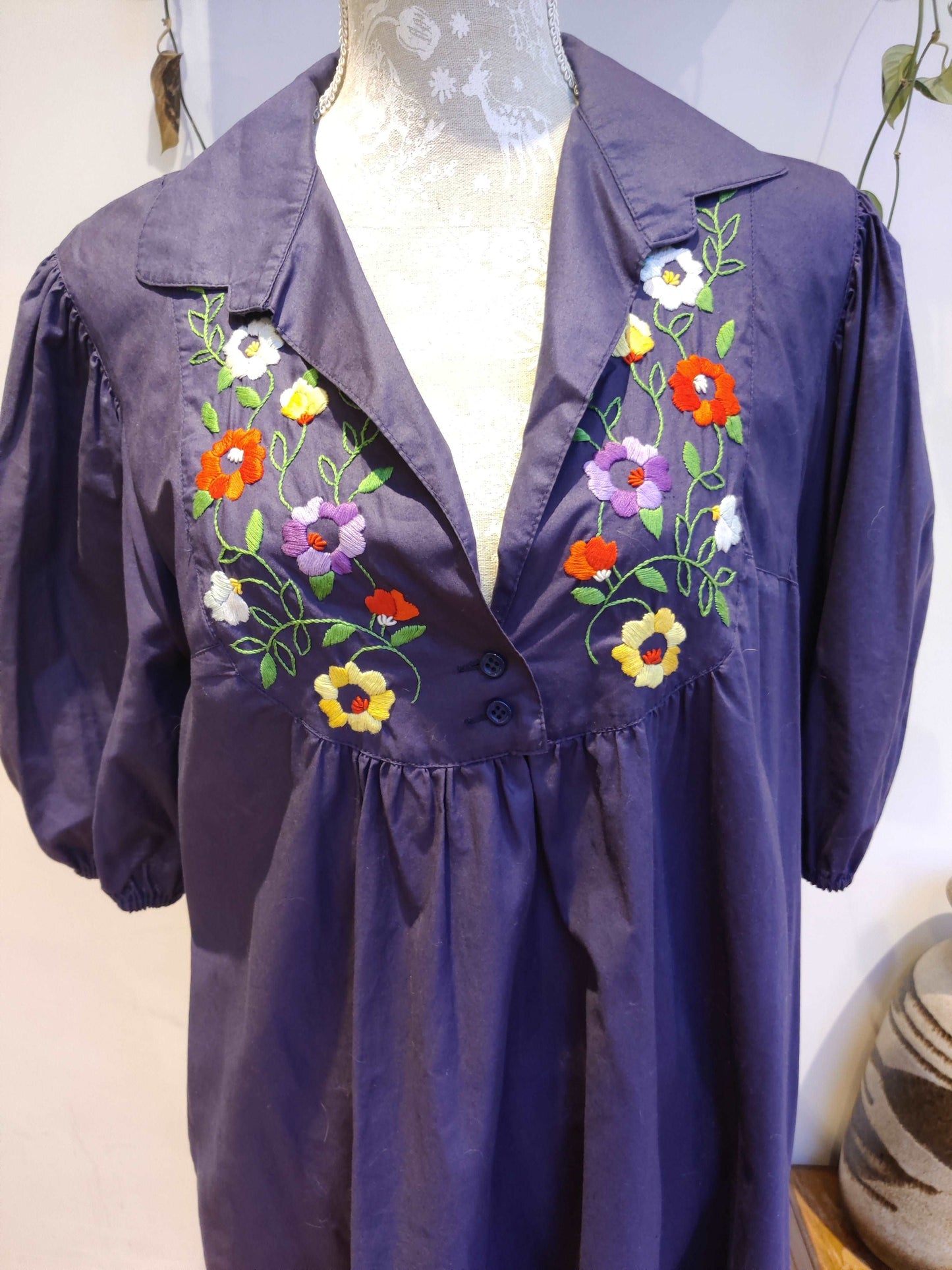 Beautiful blue smock dress with embroidered bib detail.