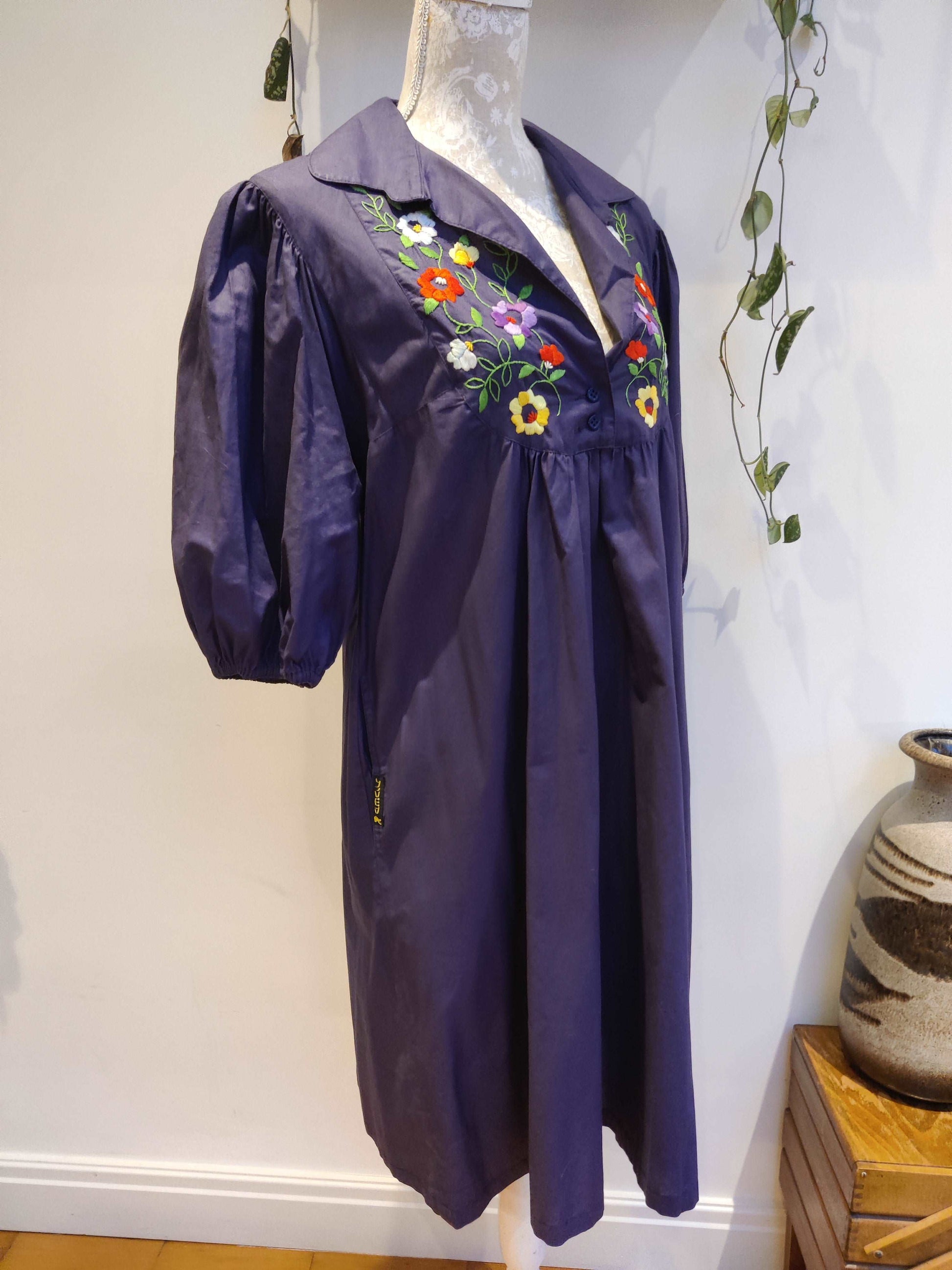 Beautiful blue smock dress with embroidered bib detail.