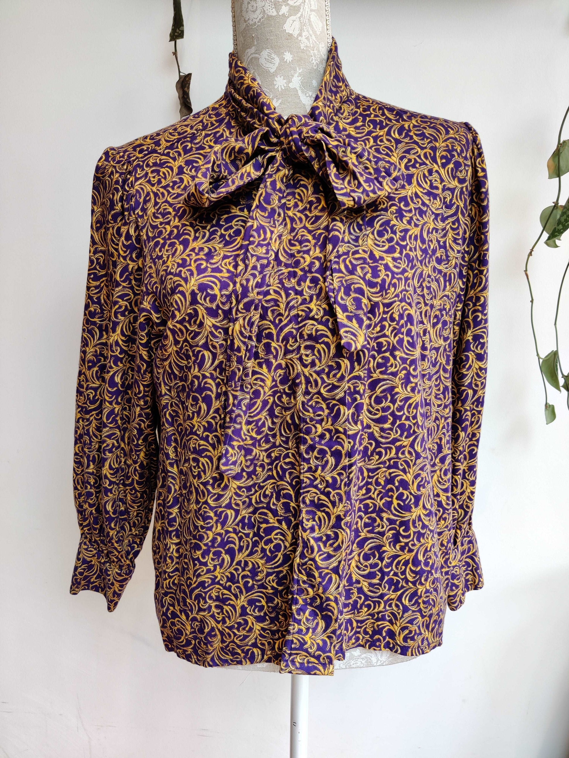 Beautiful 80s pussybow blouse in purple and gold print.  Size 12-14.