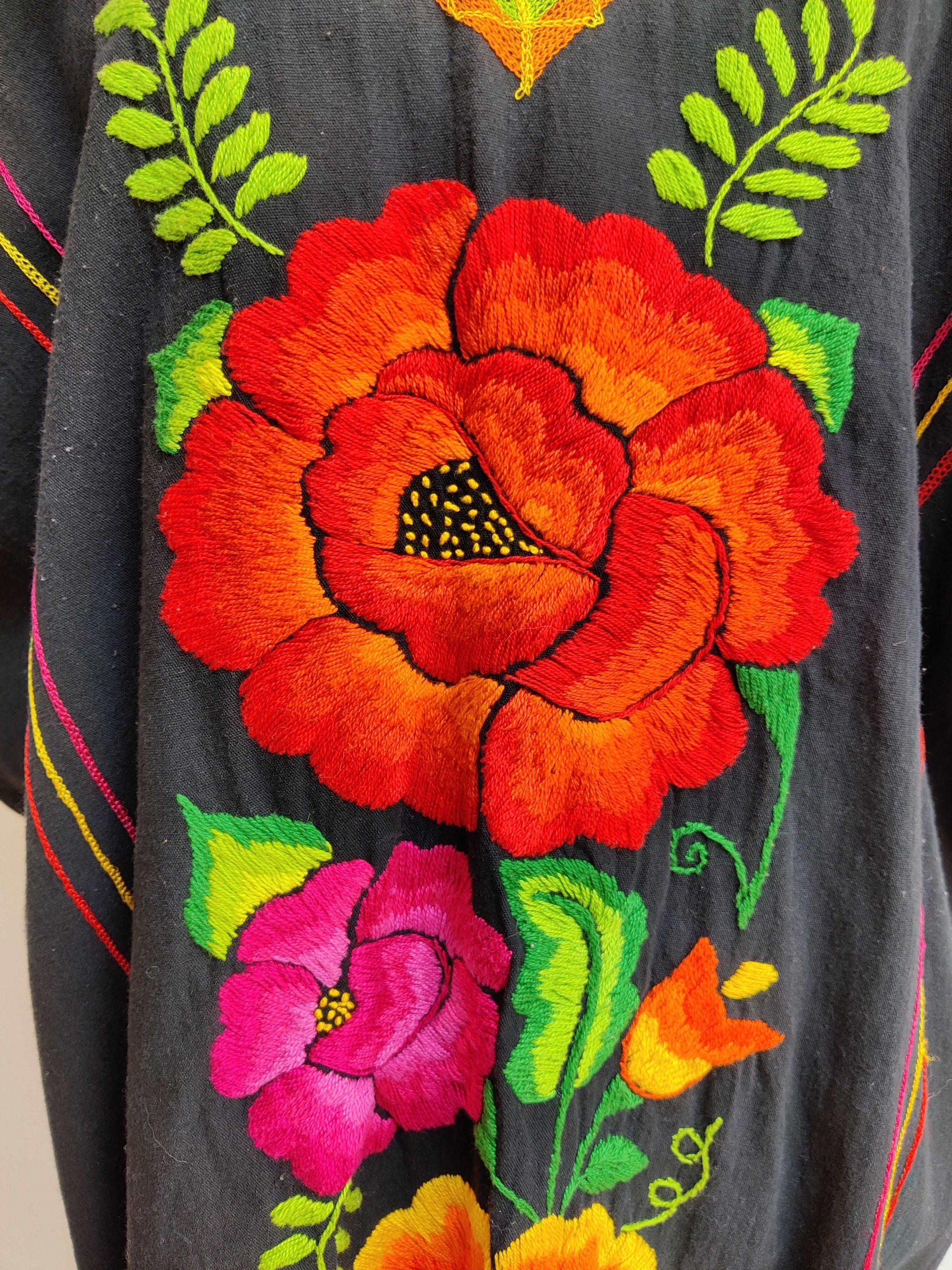 embroidered flower detail on black kaftan