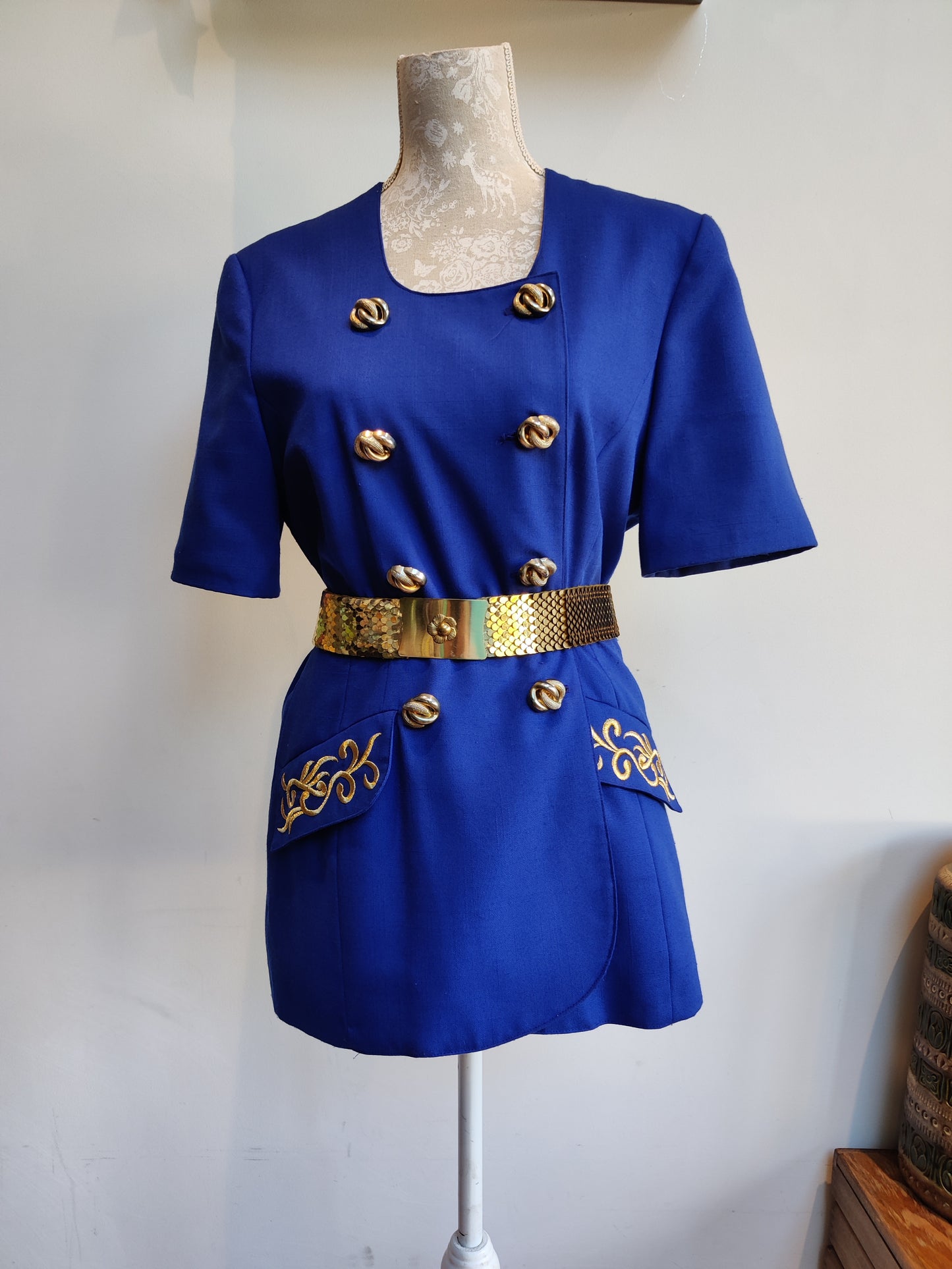 Blue and gold short sleeved jacket. 12.