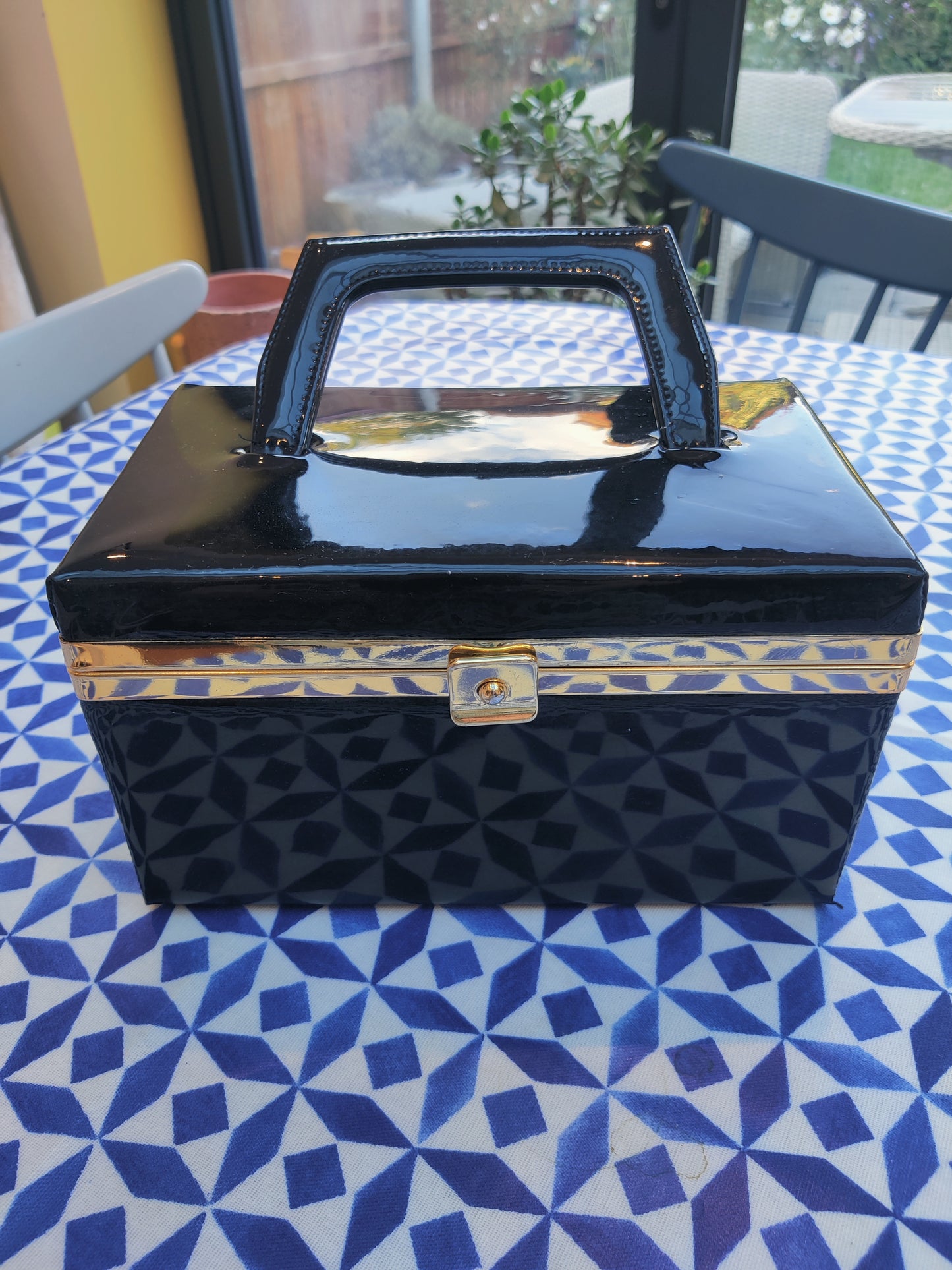 Vintage vanity box bag in black and gold.