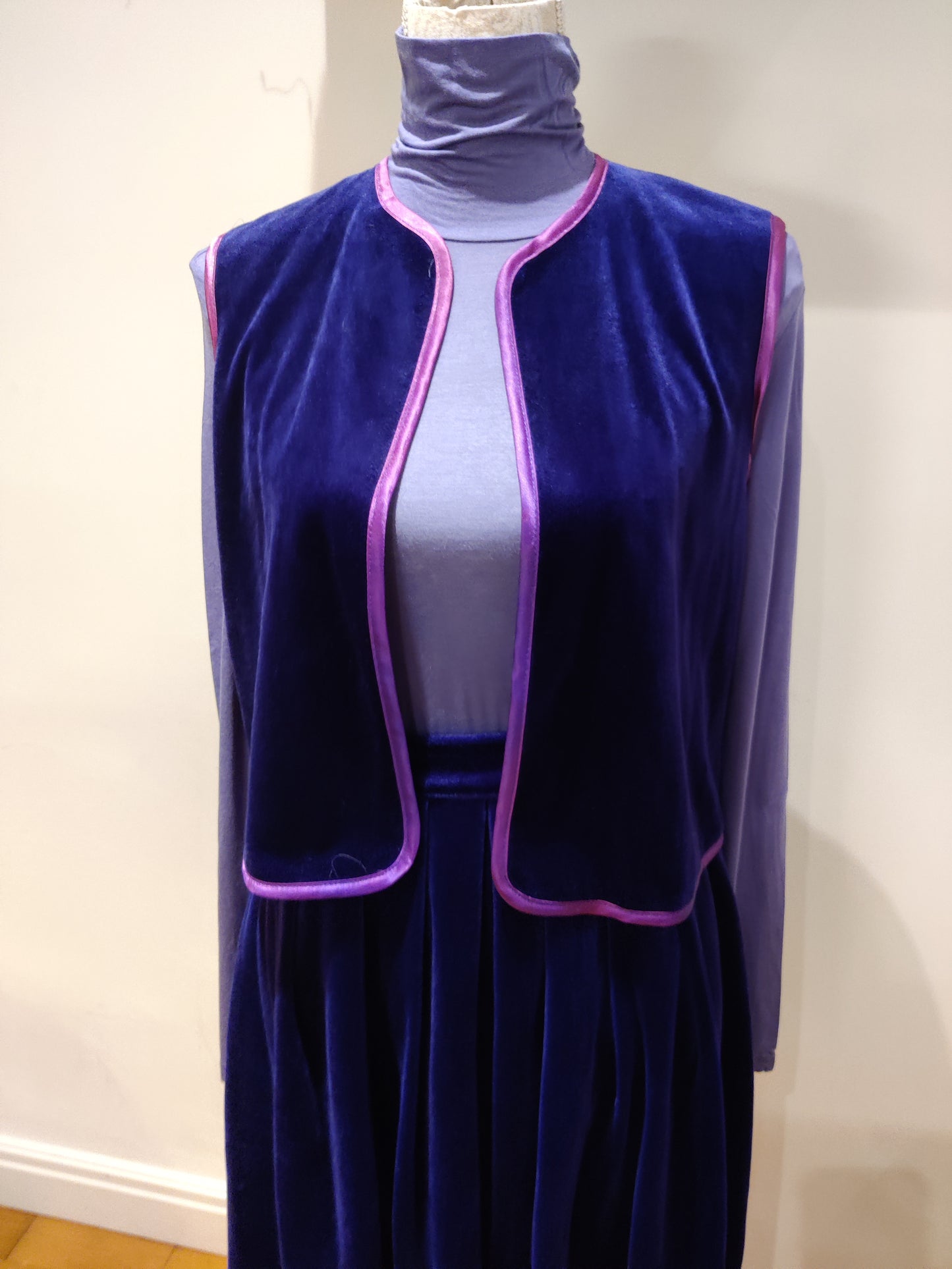 Vibrant blue velvet waistcoat with purple trim.