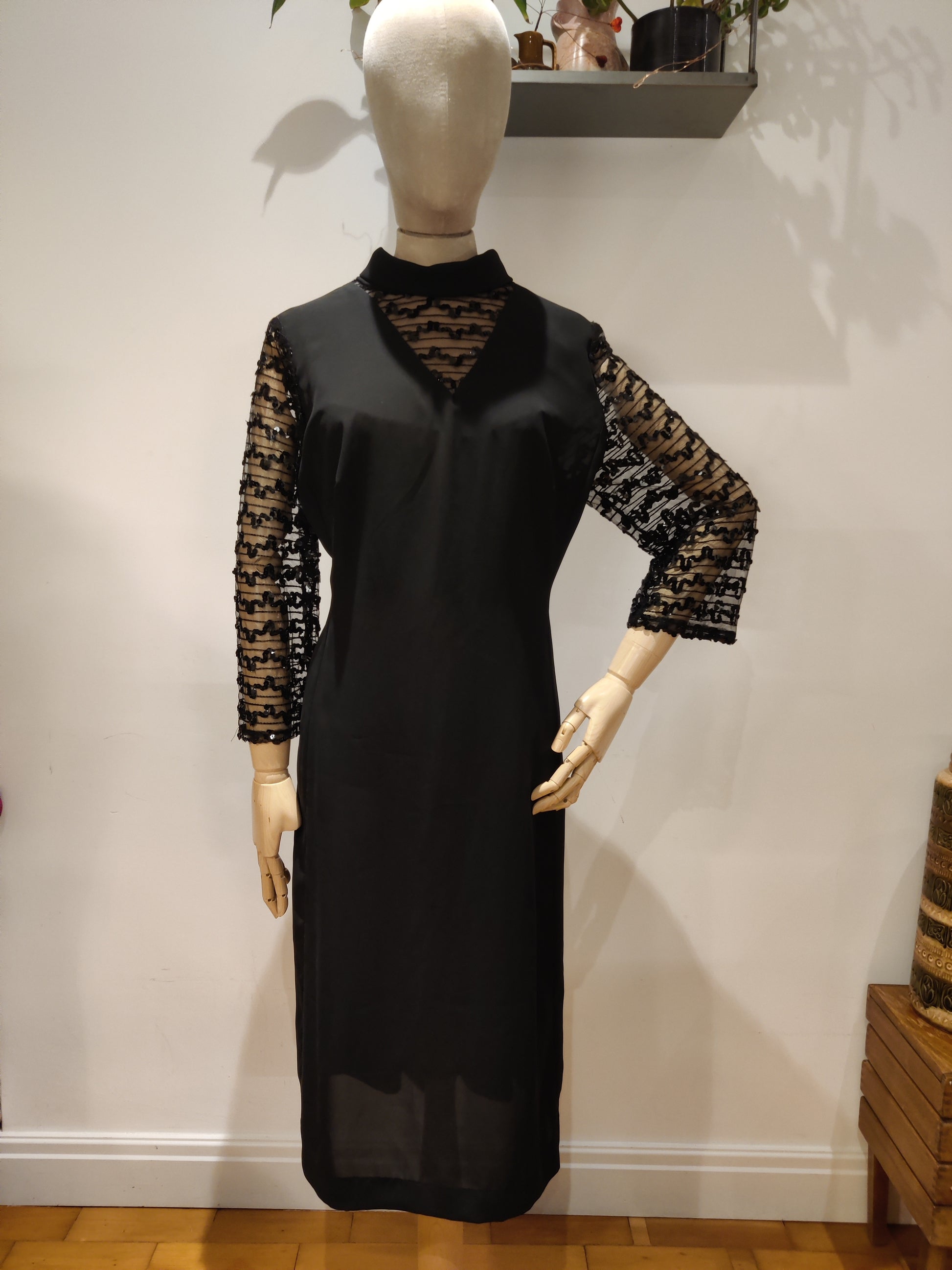 Beautiful black vintage dress with high neck and sequin sleeves.