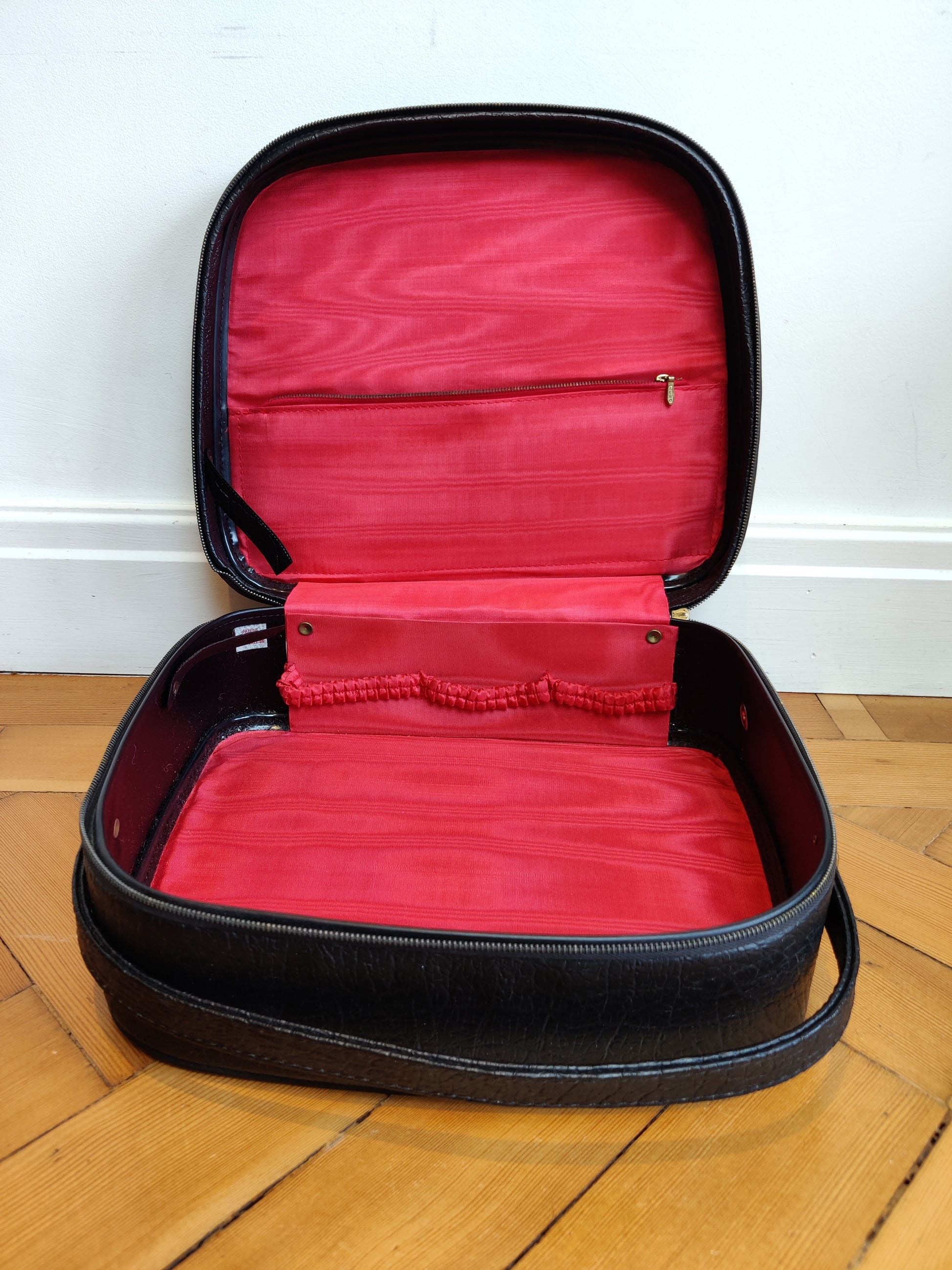 black vintage vanity case with bright red lining