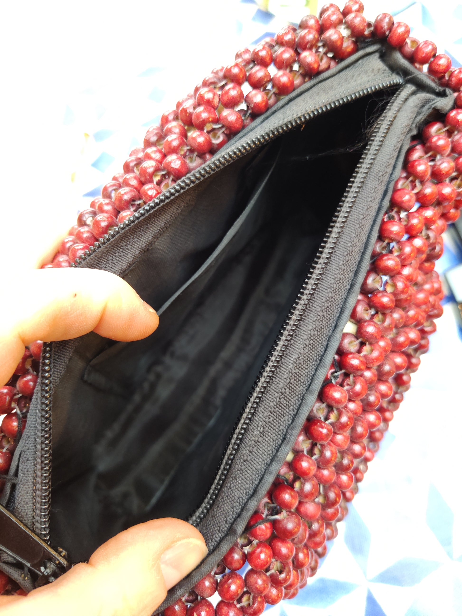 Red beaded bag with cream beaded diamond placement