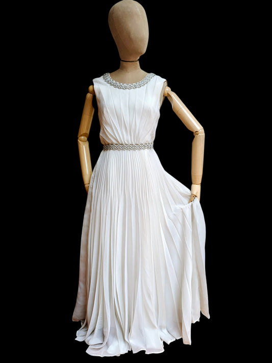 Beautiful 1960's sleeveless white wedding dress with silver embellishments. Size 8.