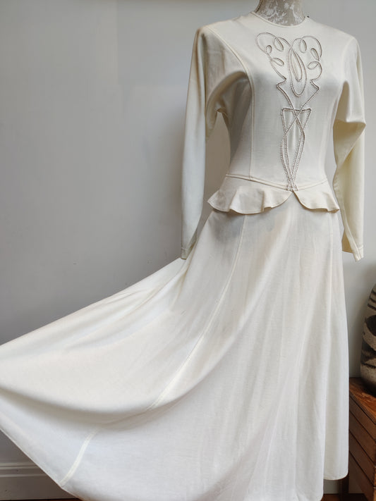 Cream vintage peplum dress with embroidered trim. 