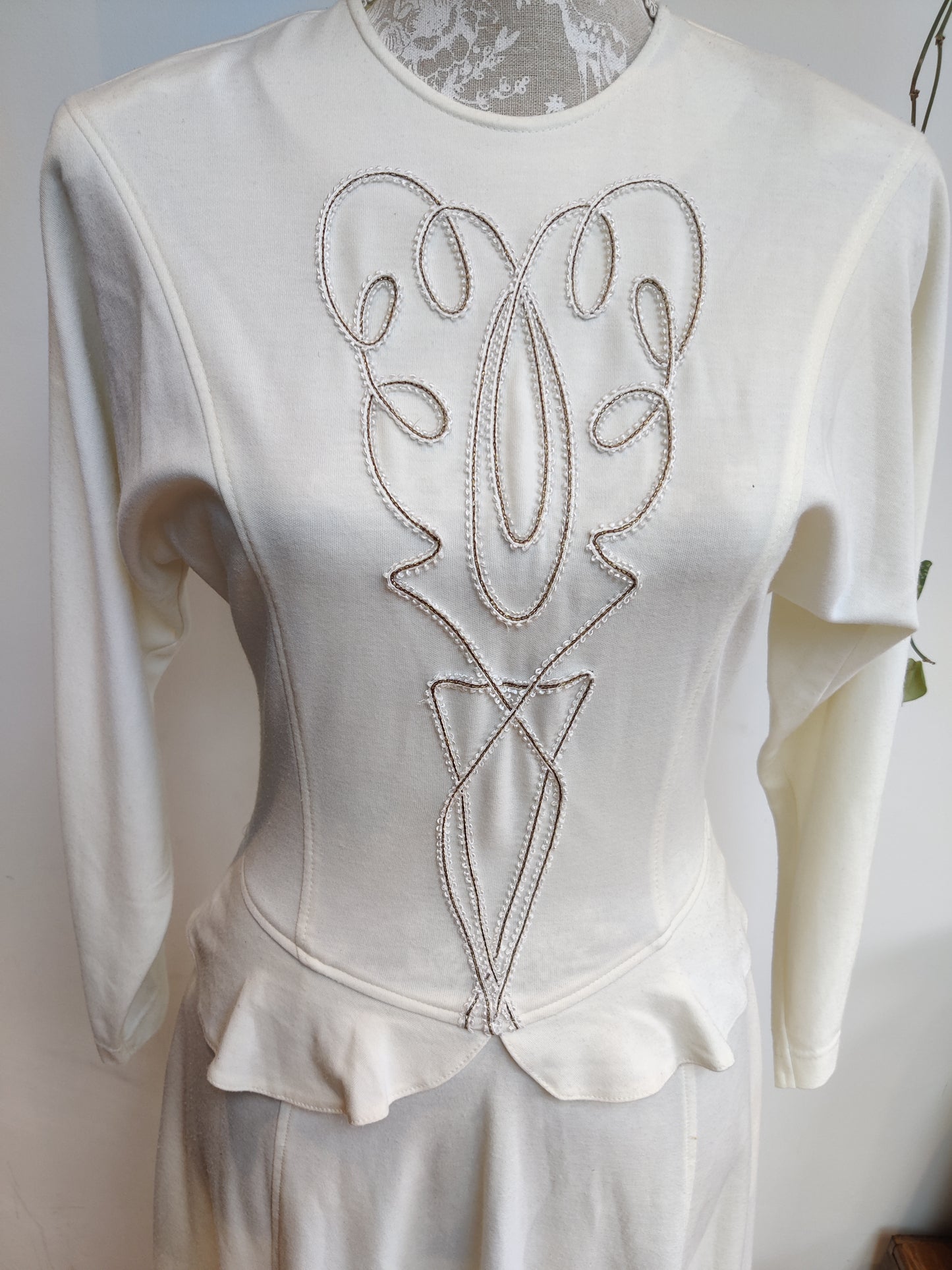Beautiful embroidery detail on cream peplum dress