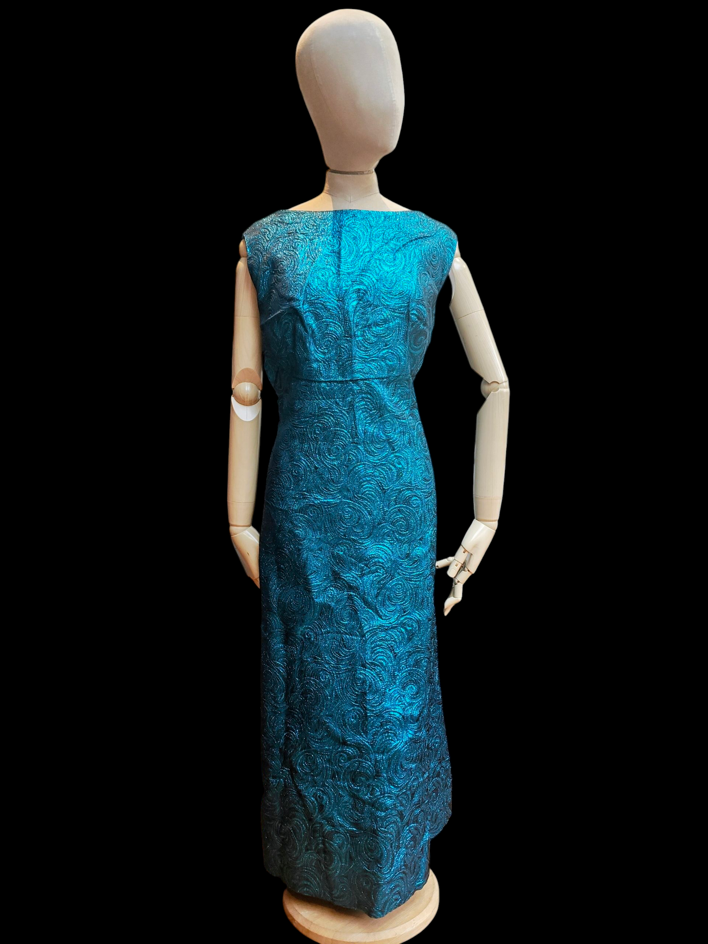 Mannequin wearing a blue dress on a black background
