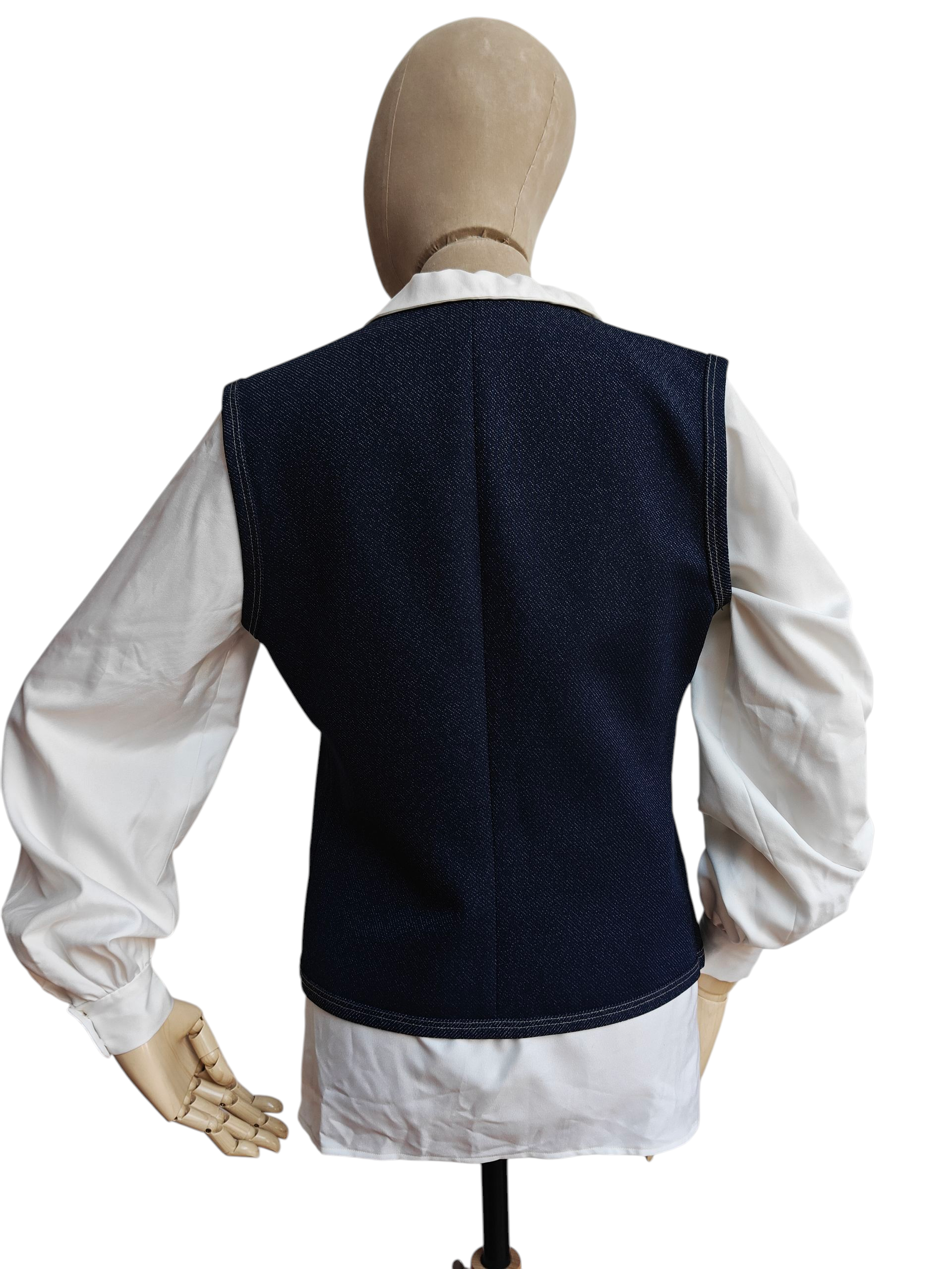 Mannequin wearing a navy blue vest over a white shirt on a white background