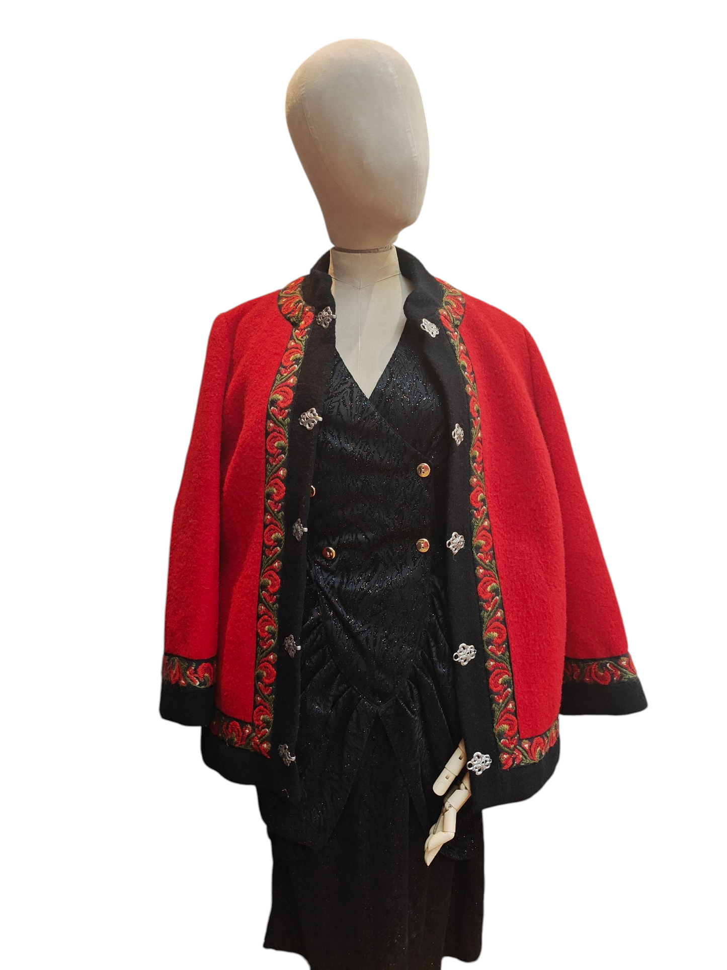 Red jacket with intricate patterns on a mannequin against a white background