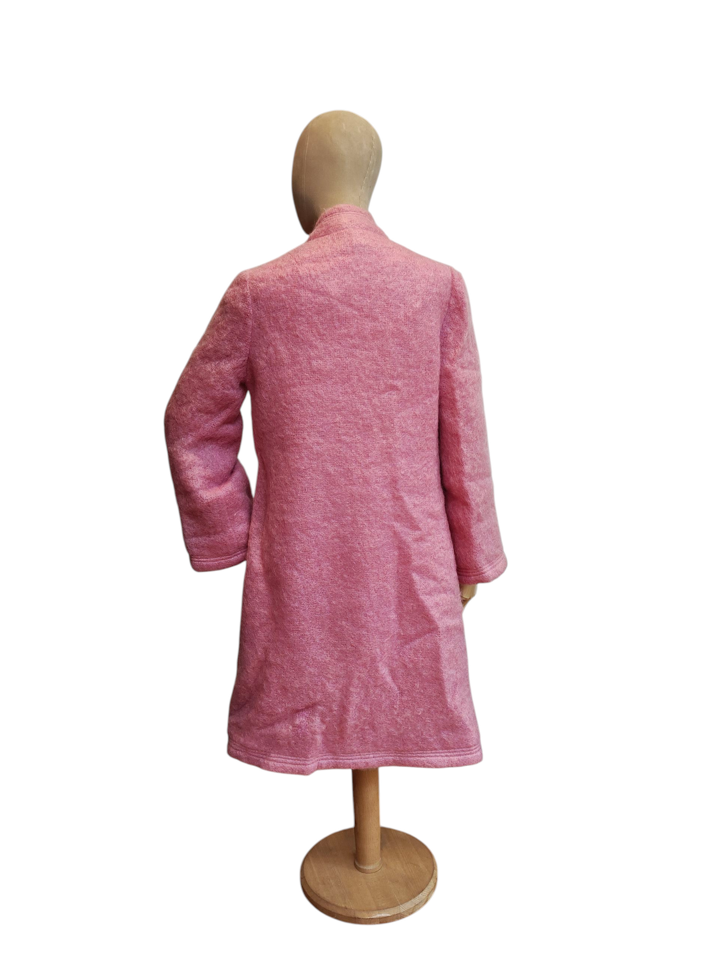 Pink coat on a mannequin against a white background