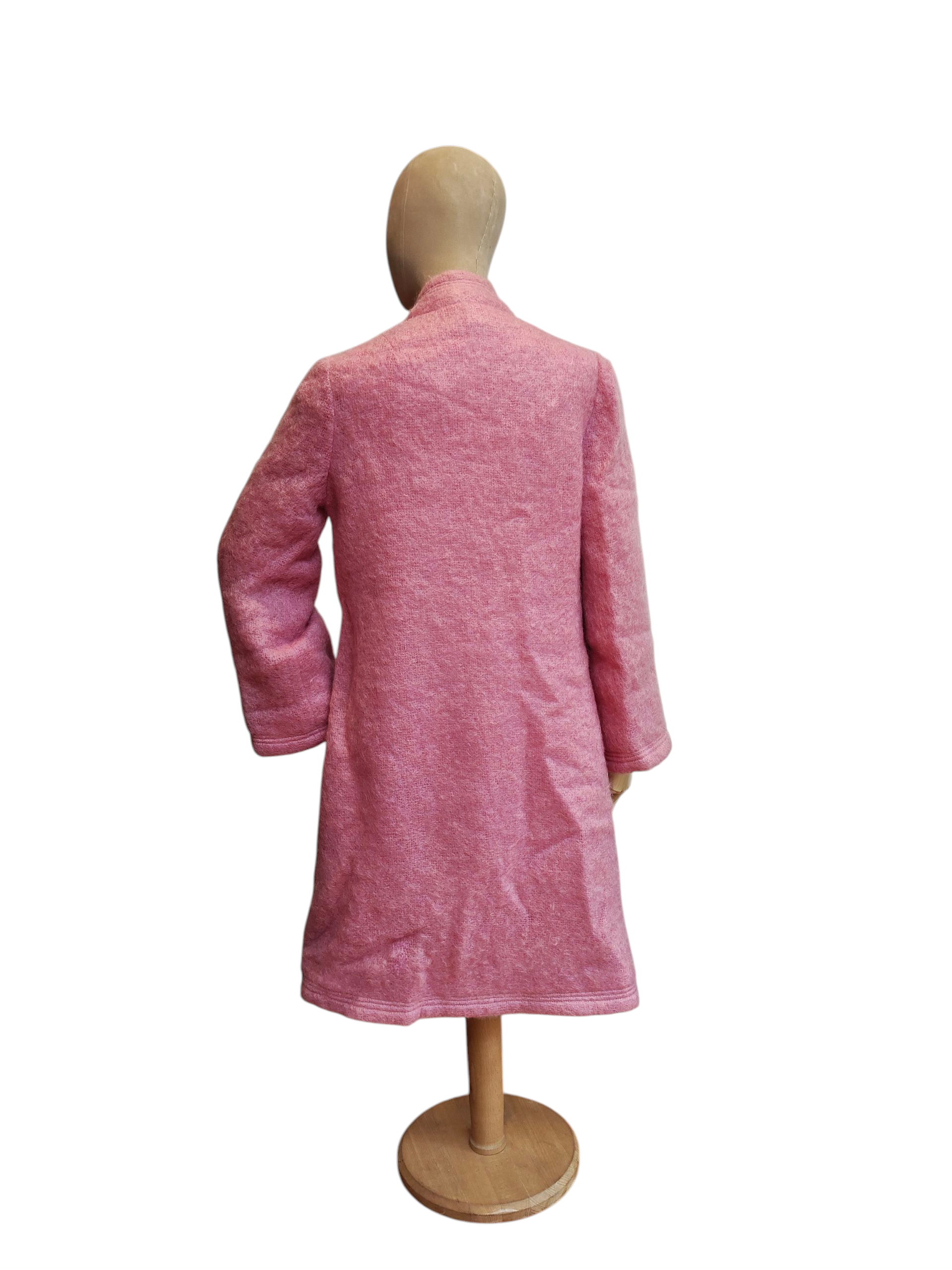 Pink coat on a mannequin against a white background