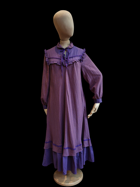 Purple dress on a mannequin against a black background