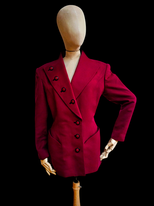 Red blazer on a mannequin against a black background